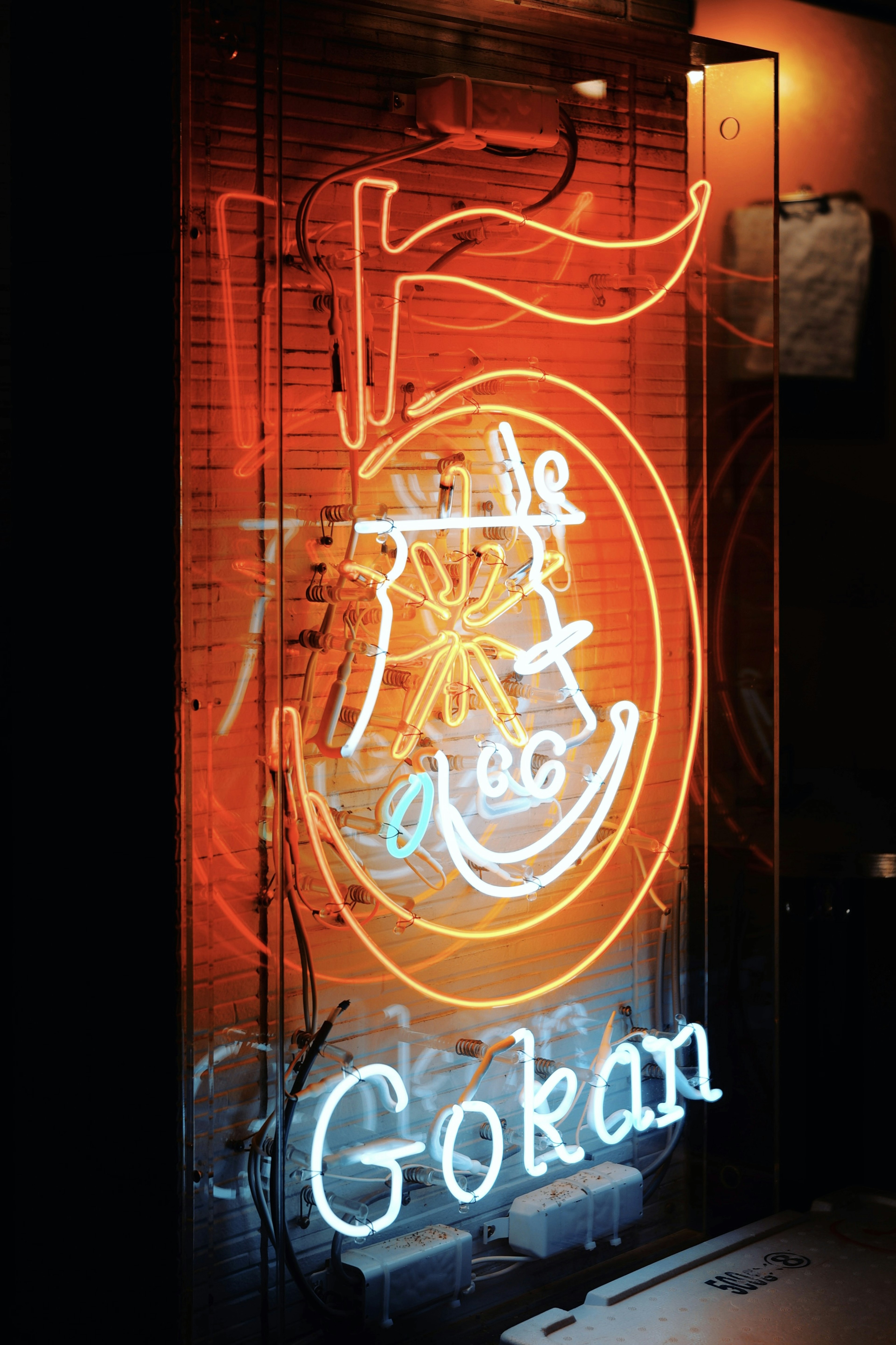 Neon sign featuring the number 5 and the word Gokan