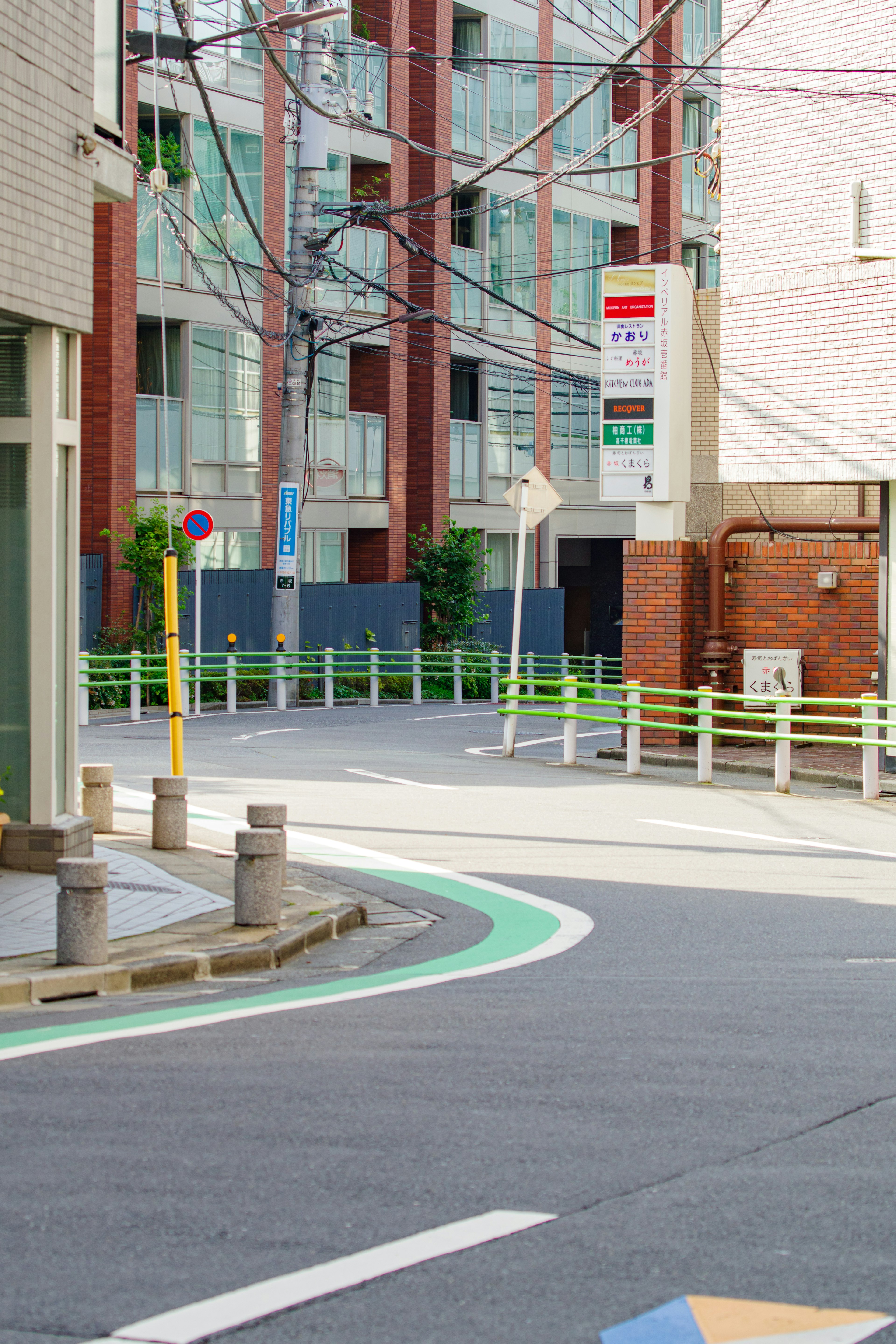 Urban street corner featuring a green bike lane and modern buildings