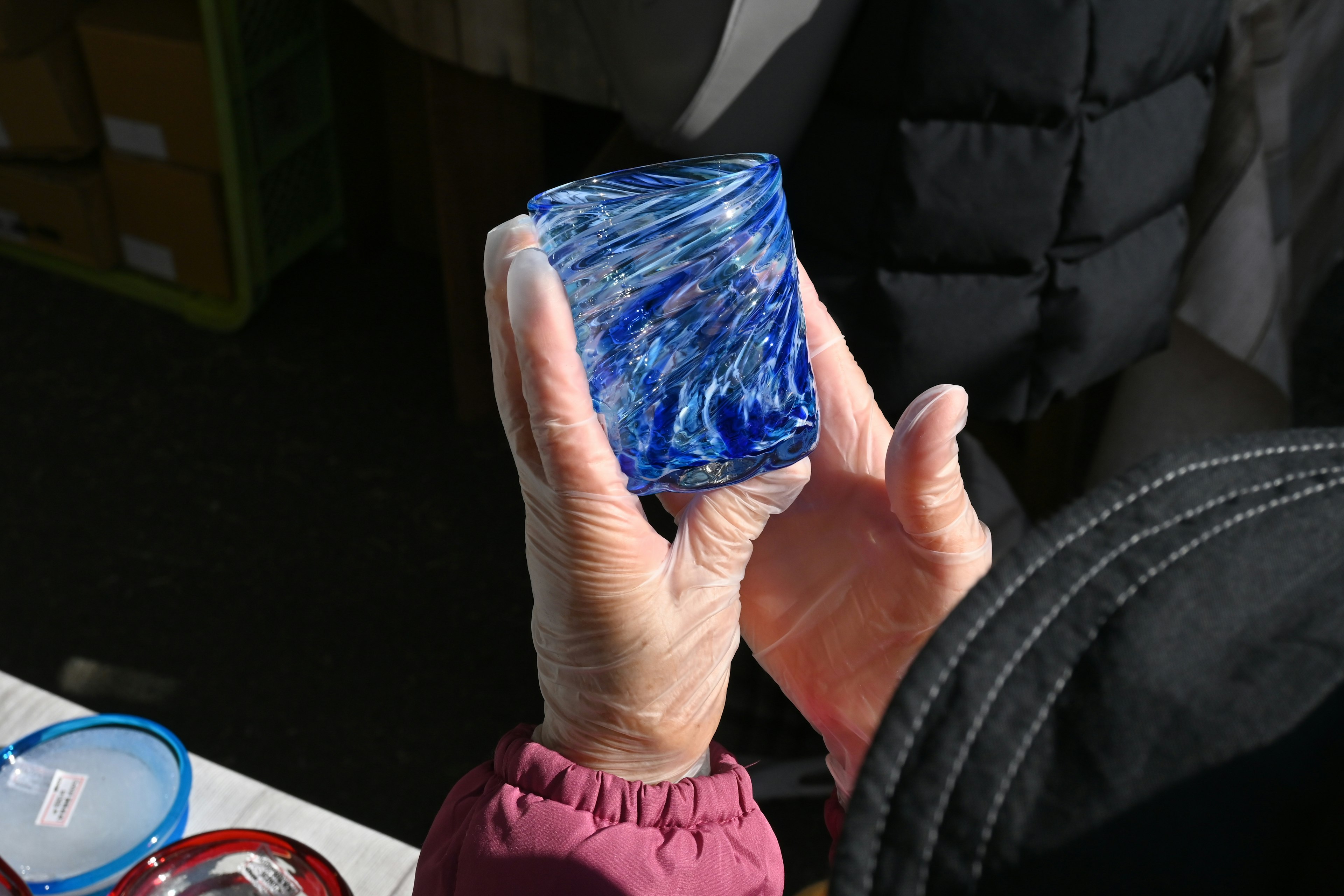 Person holding a blue marbled glass object