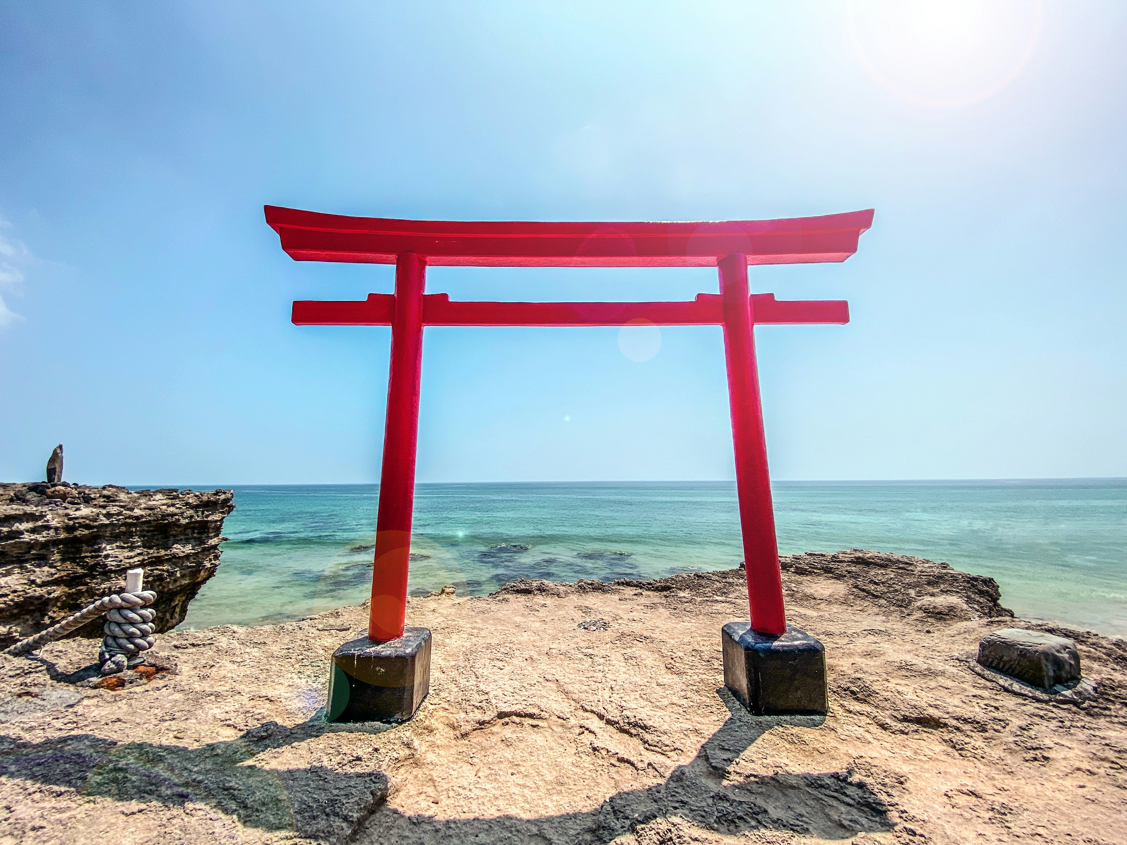 Red torii gate by the seaside