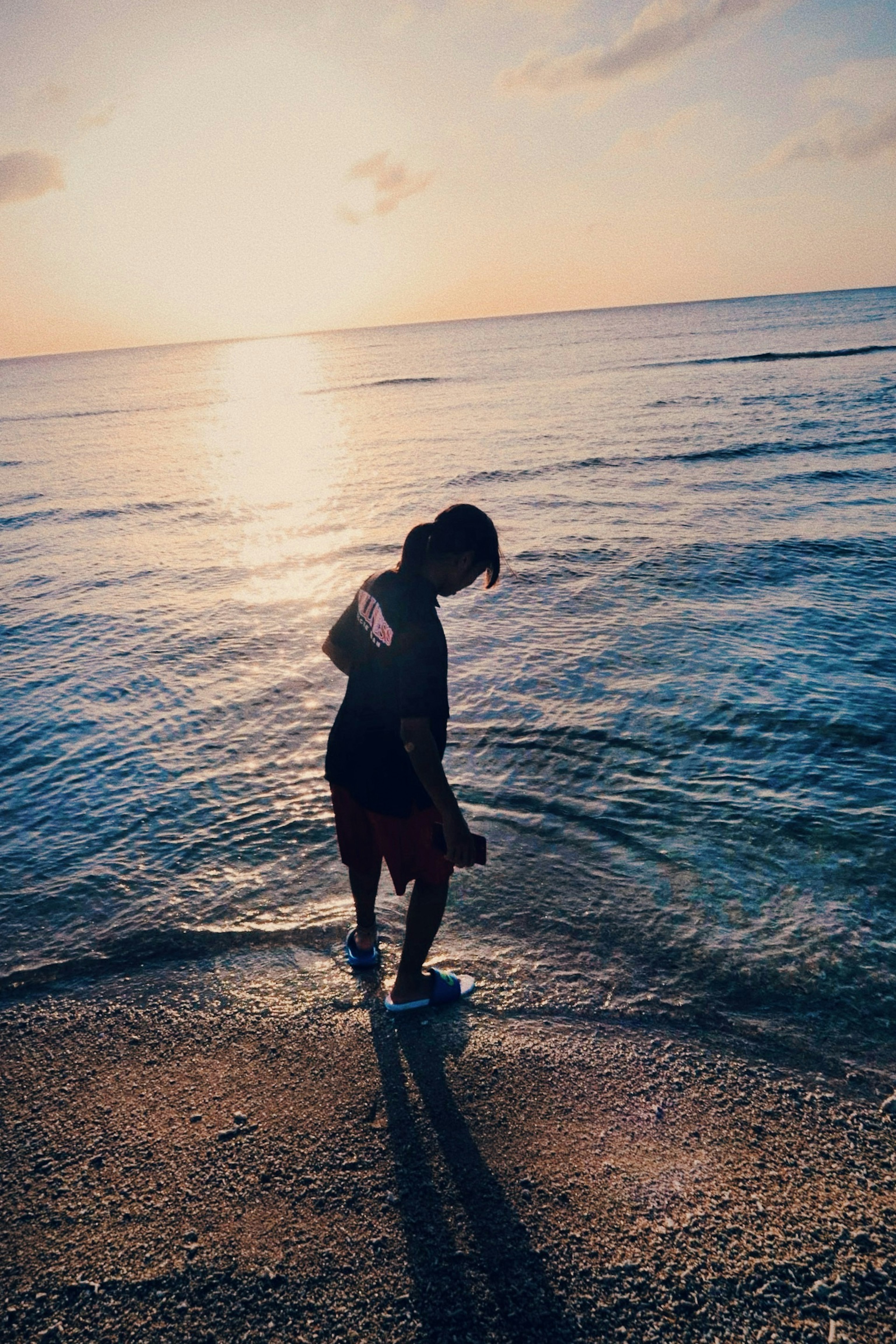 Silhouette of a person at the beach during sunset