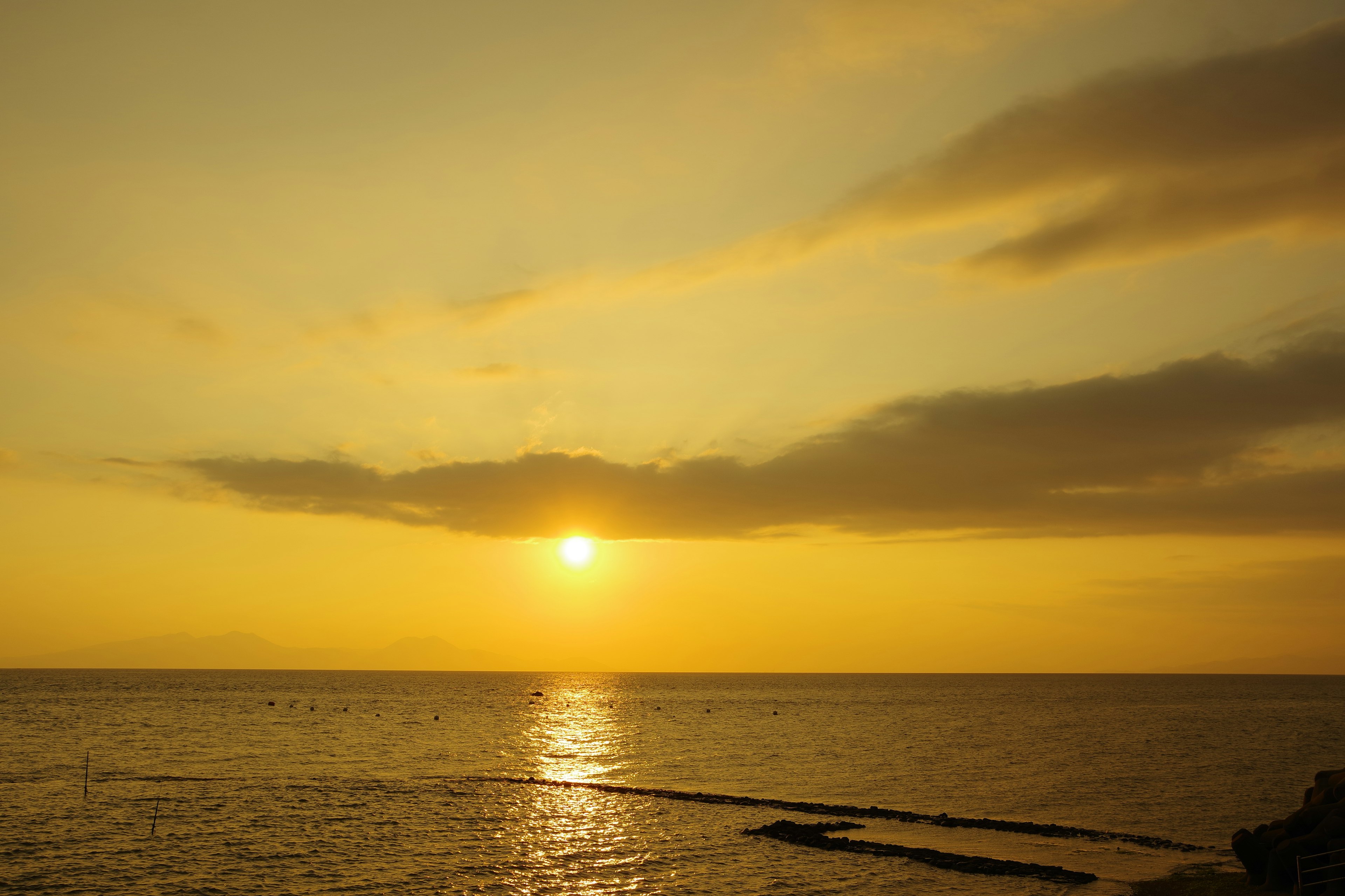 Sunset over the ocean with a golden sky