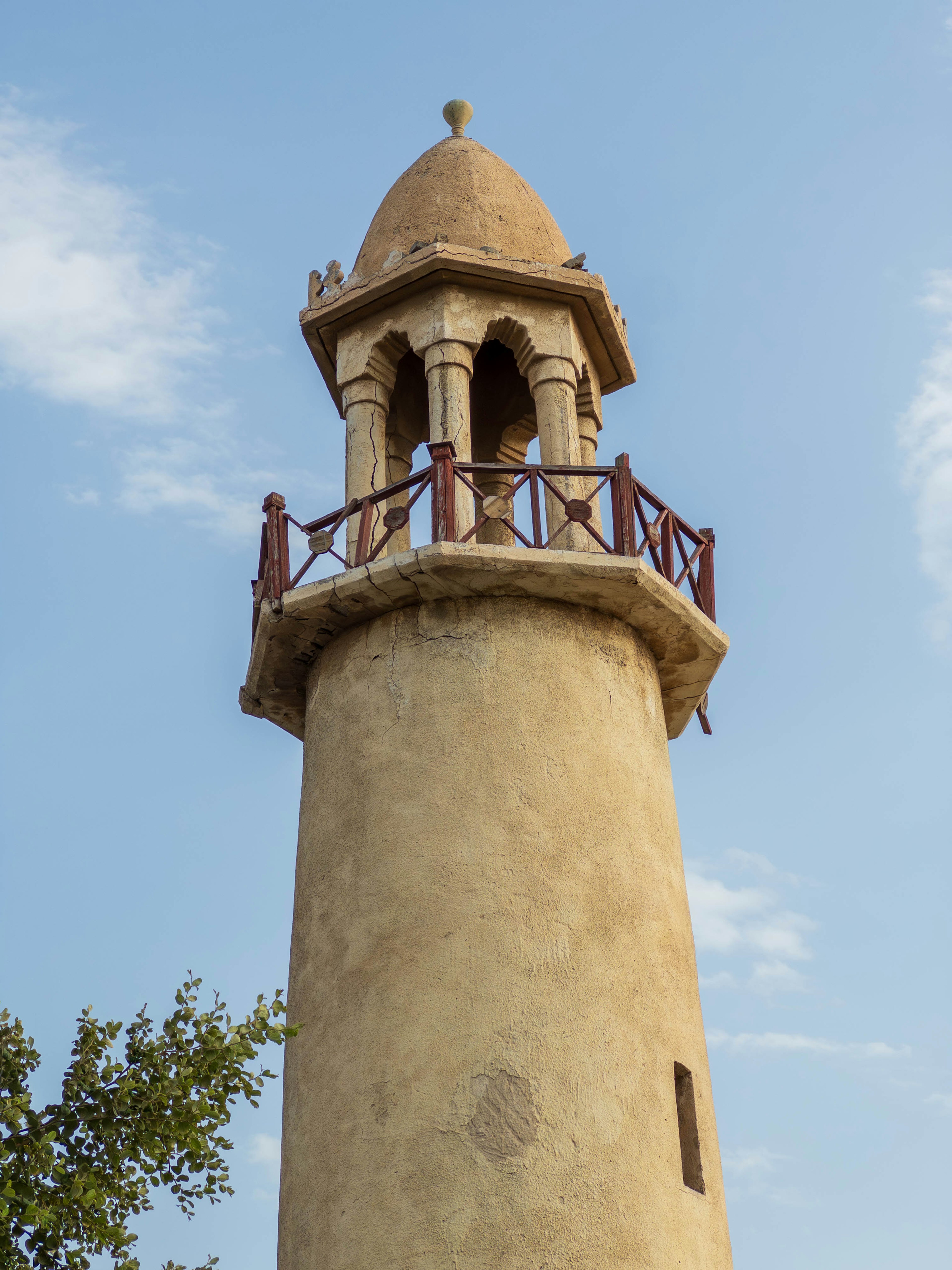 Tower with a balcony and arched windows made of sandstone