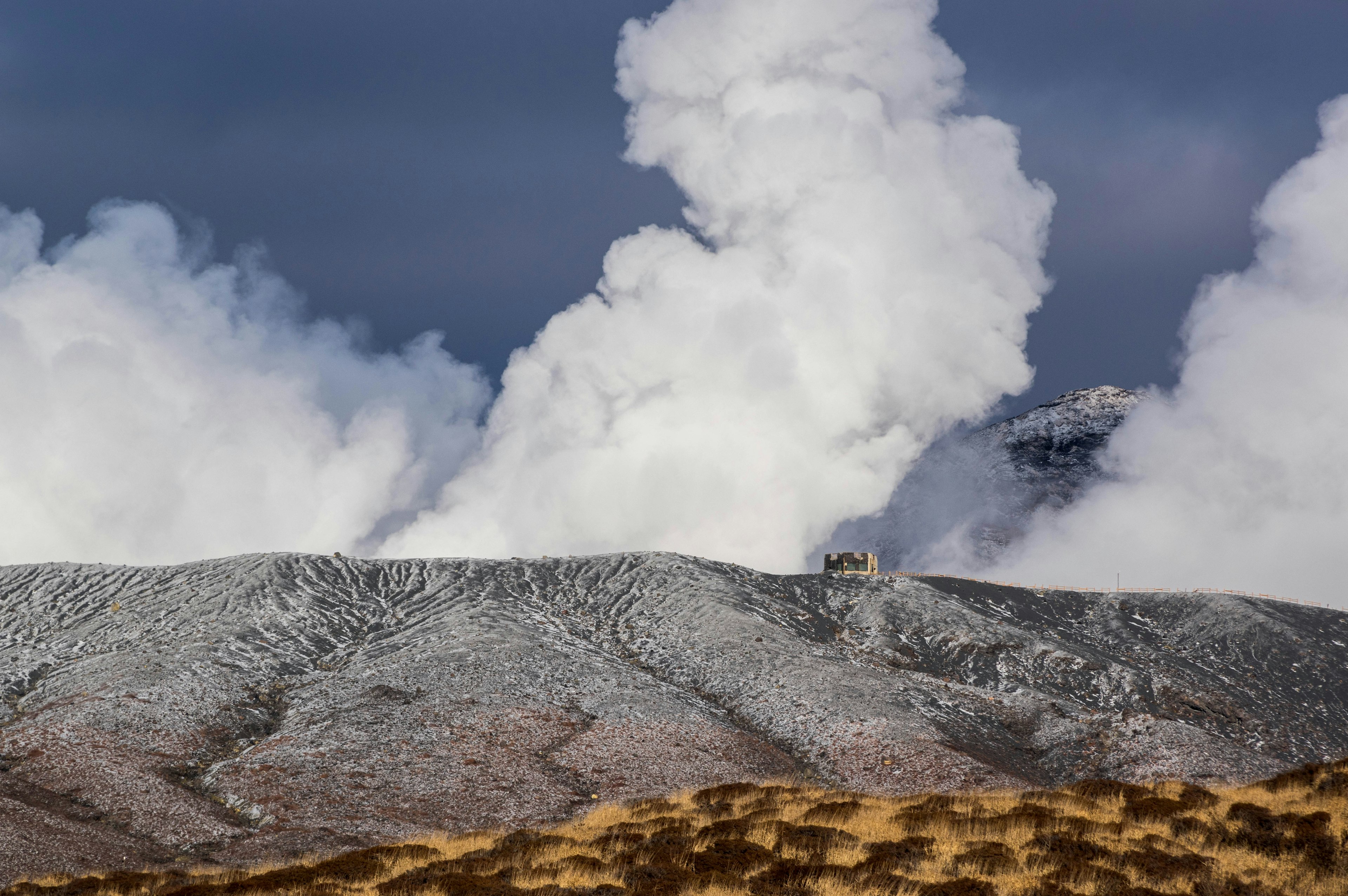 Snow-covered mountain landscape with volcanic smoke