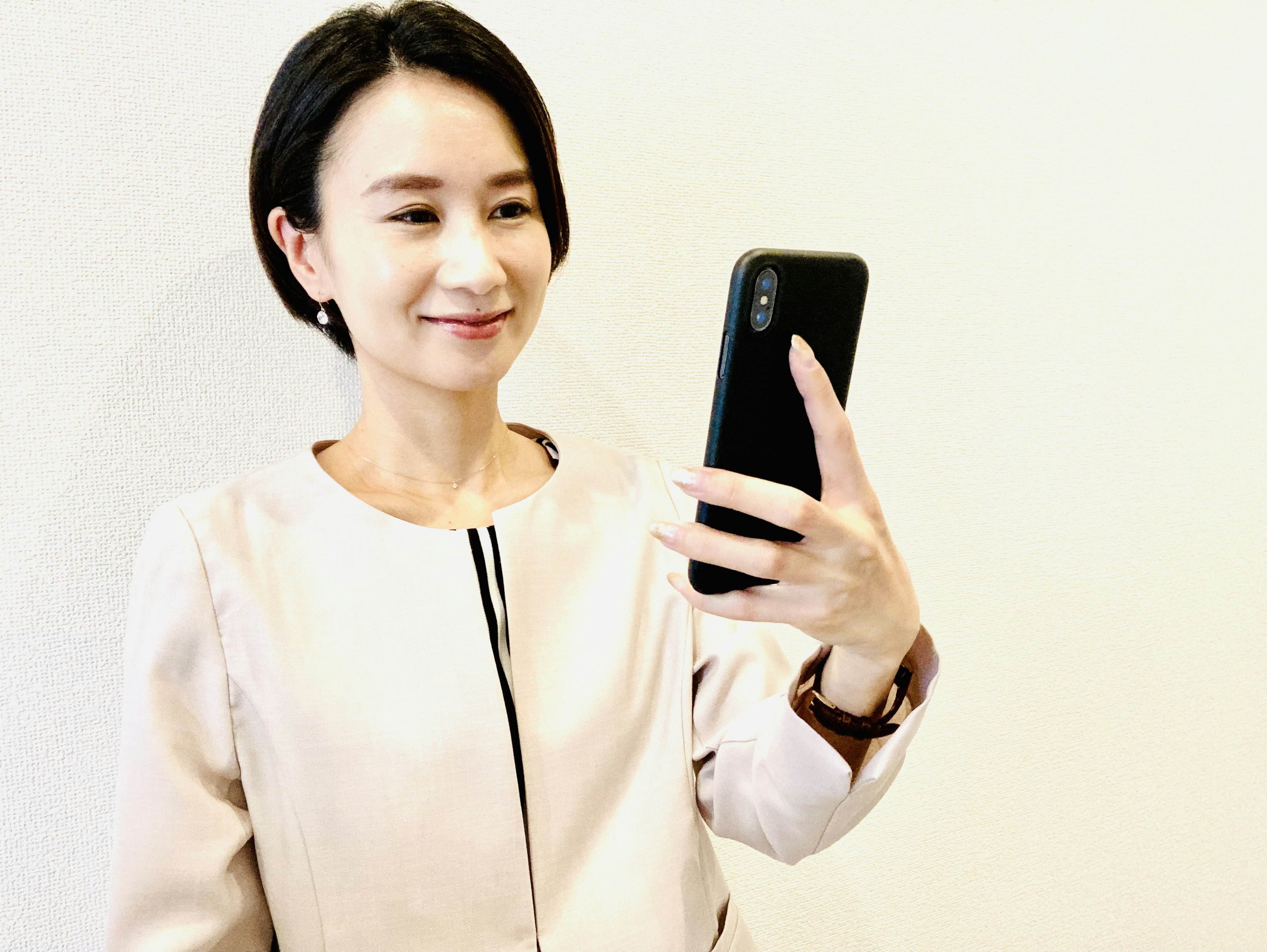 A woman taking a selfie with a smartphone