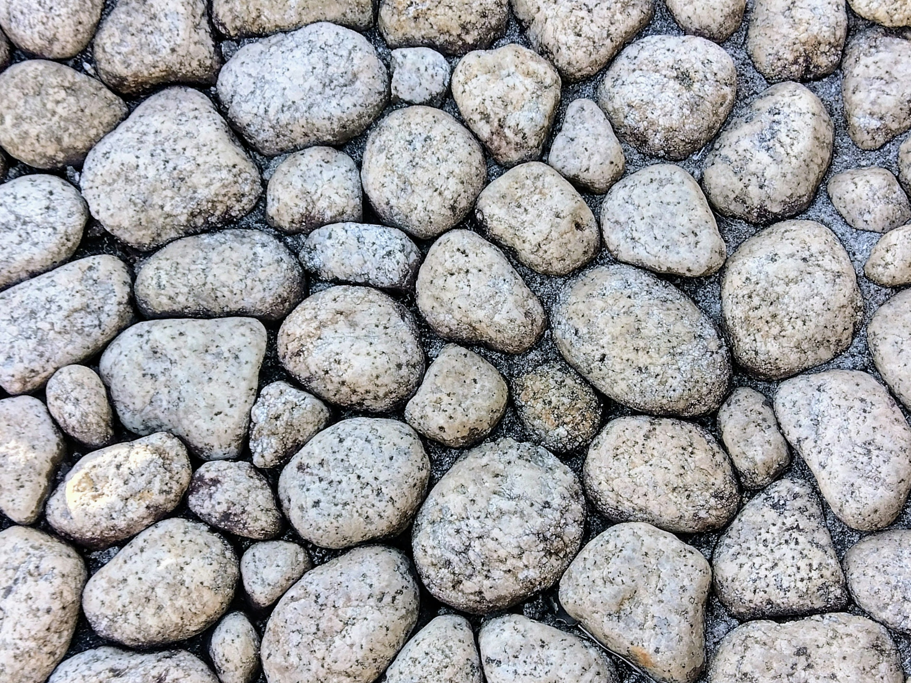 Texture of various smooth stones in a natural arrangement