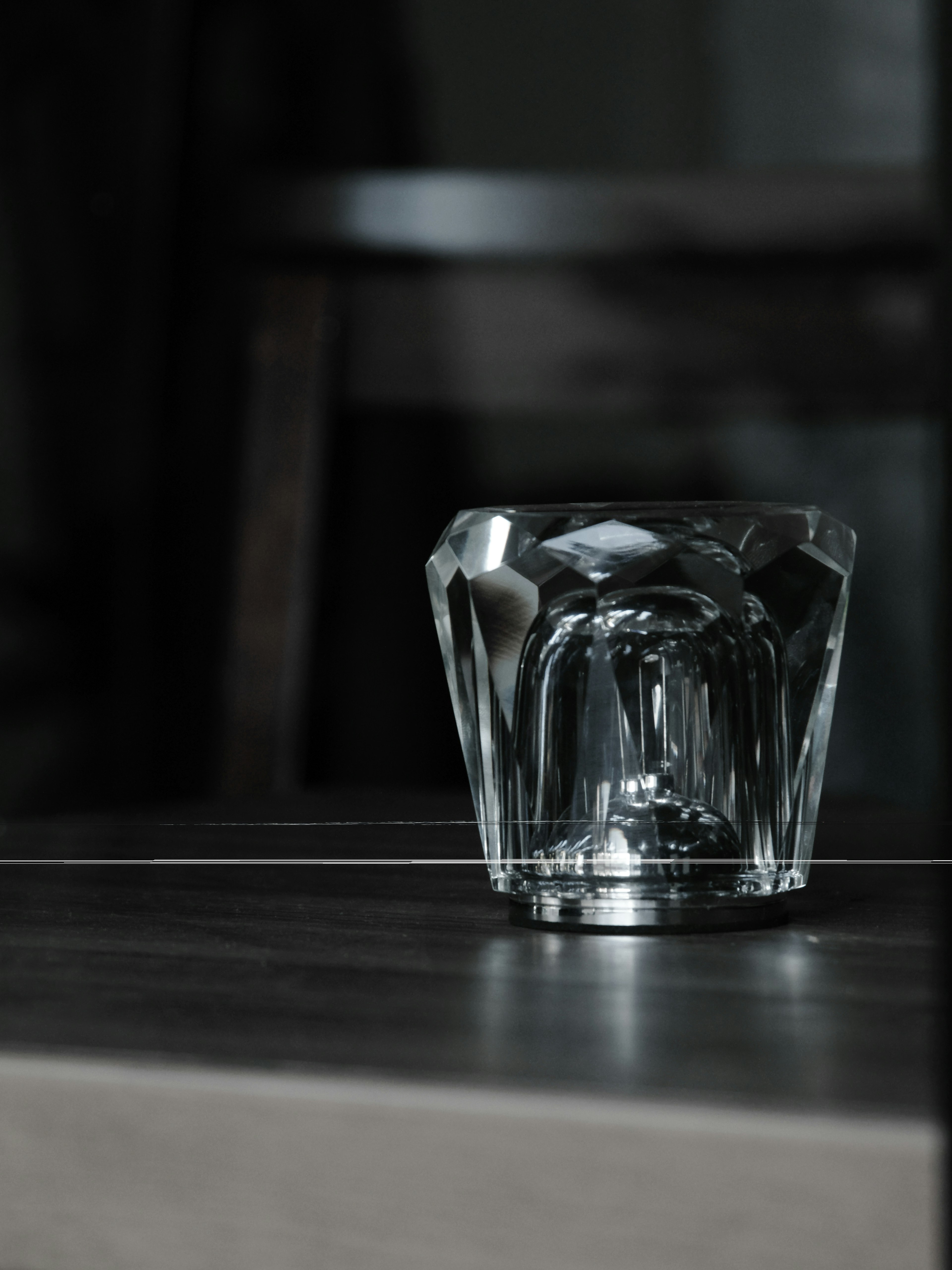 Gros plan d'un verre en cristal sur une table en bois