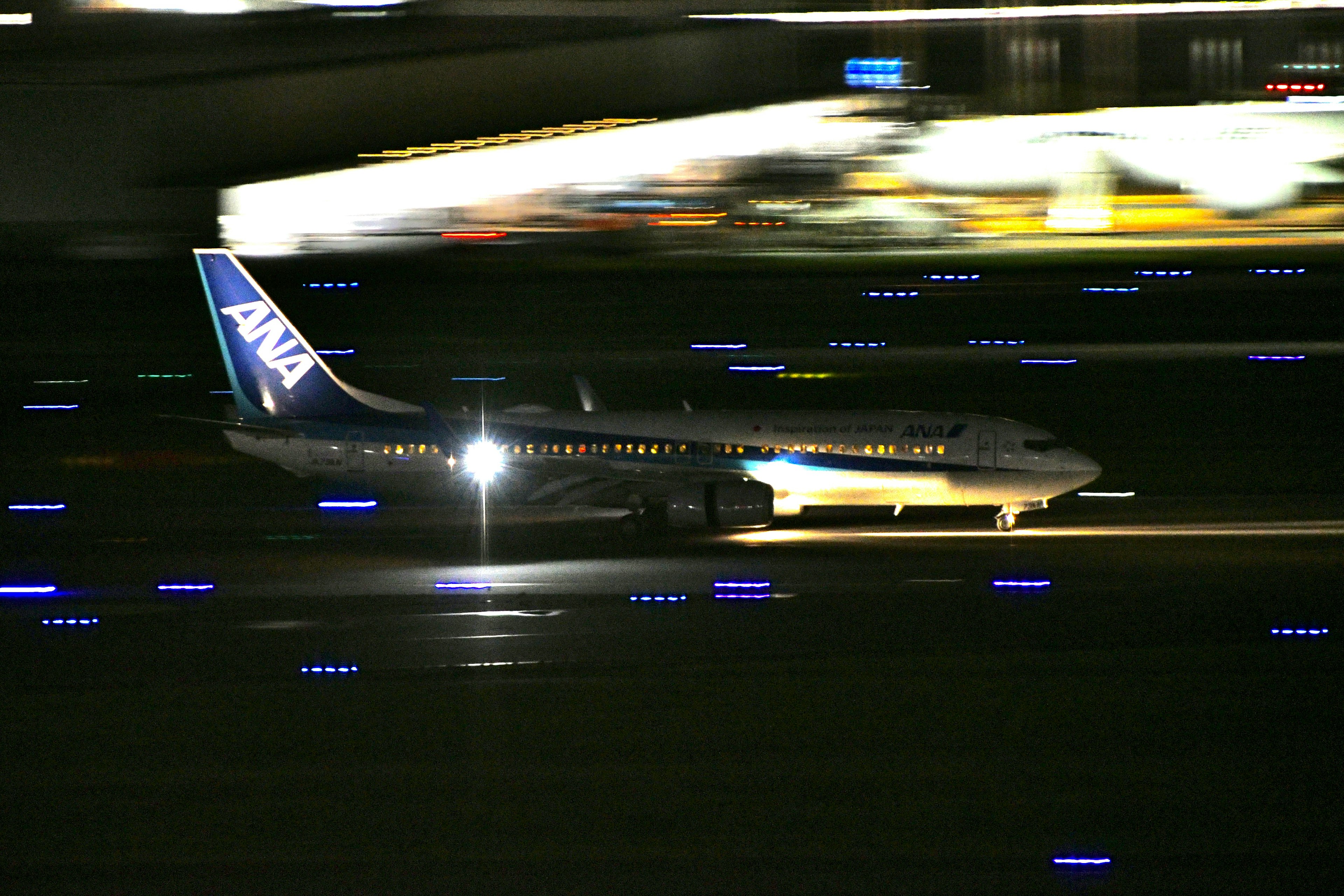 Avión de ANA rodando en la pista por la noche