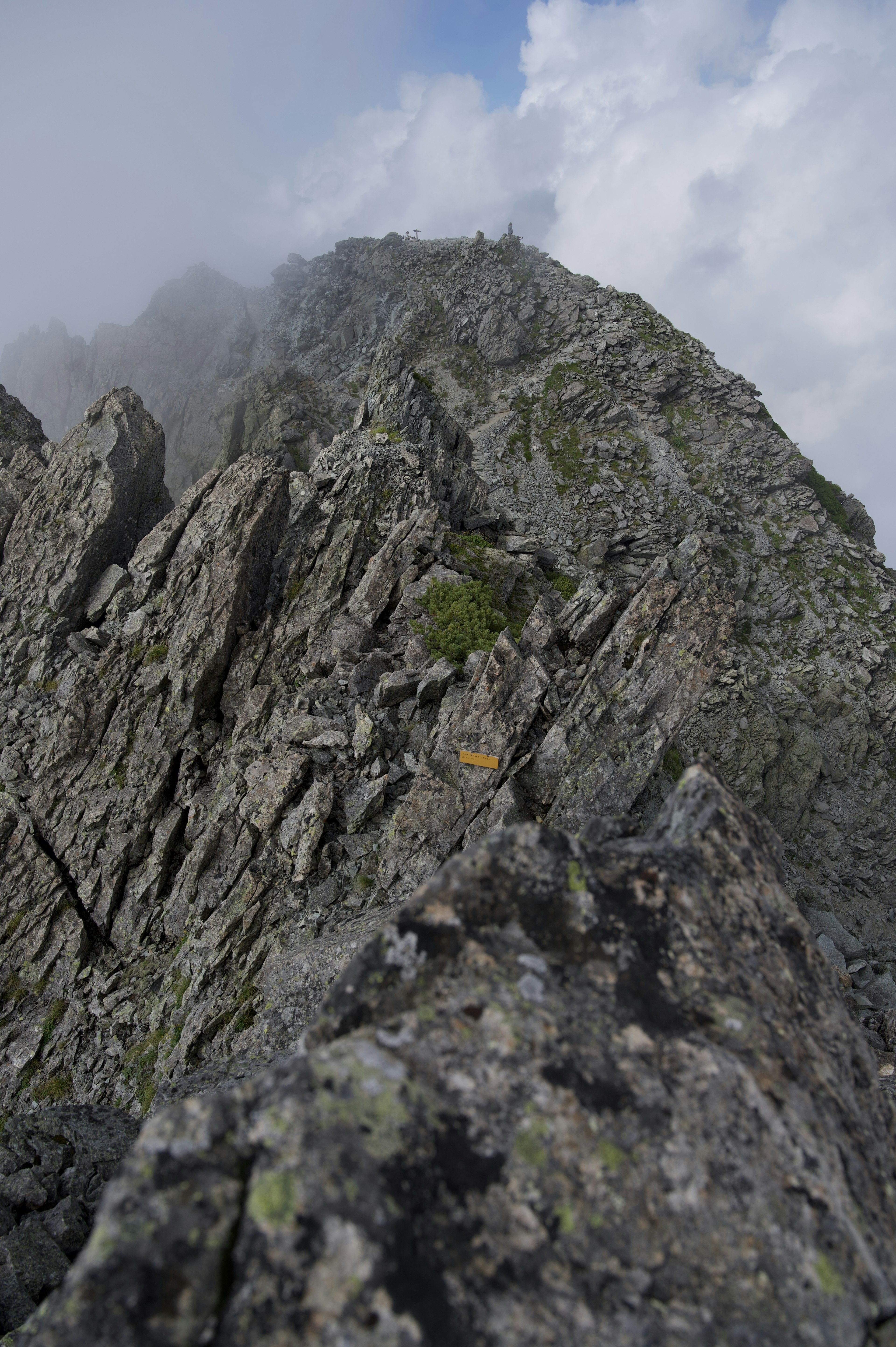 A sharp mountain ridge shrouded in clouds