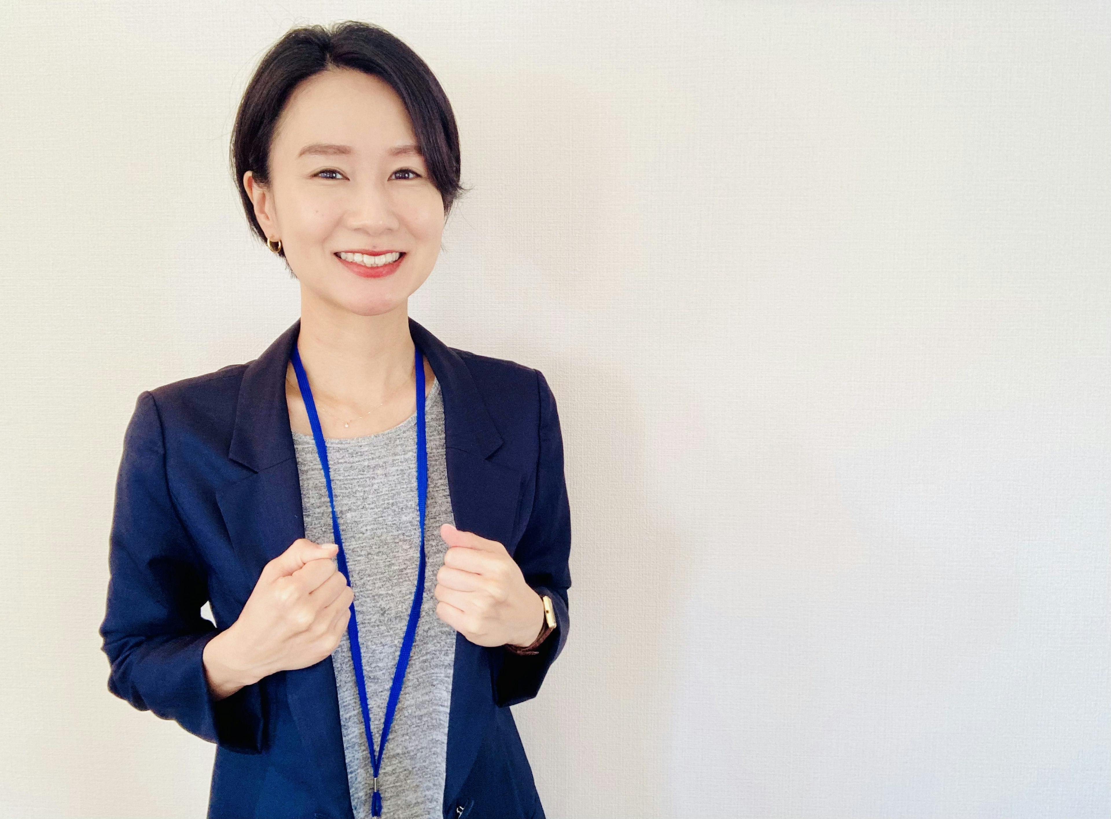 A woman in a business suit smiling at the camera