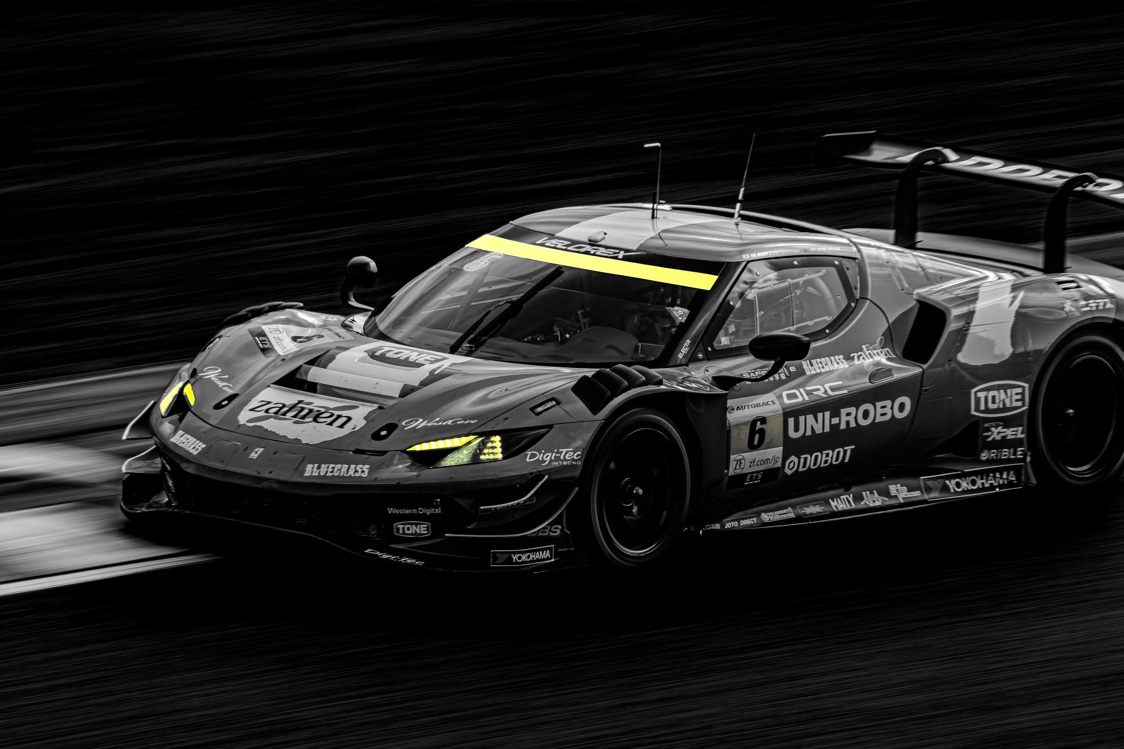 A vibrant racing car speeding on a black background