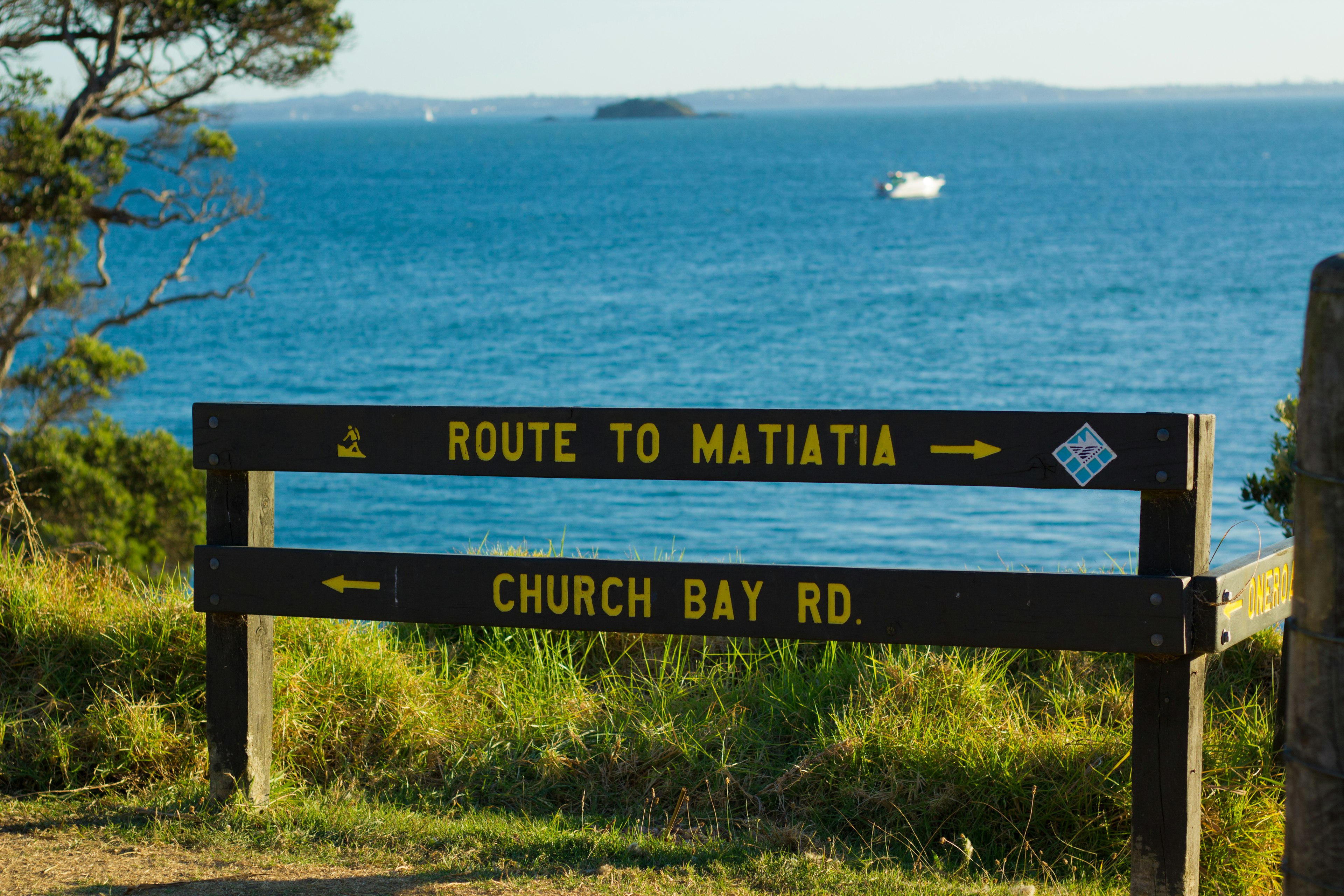 Signpost indicating route to Matiatia and Church Bay Road