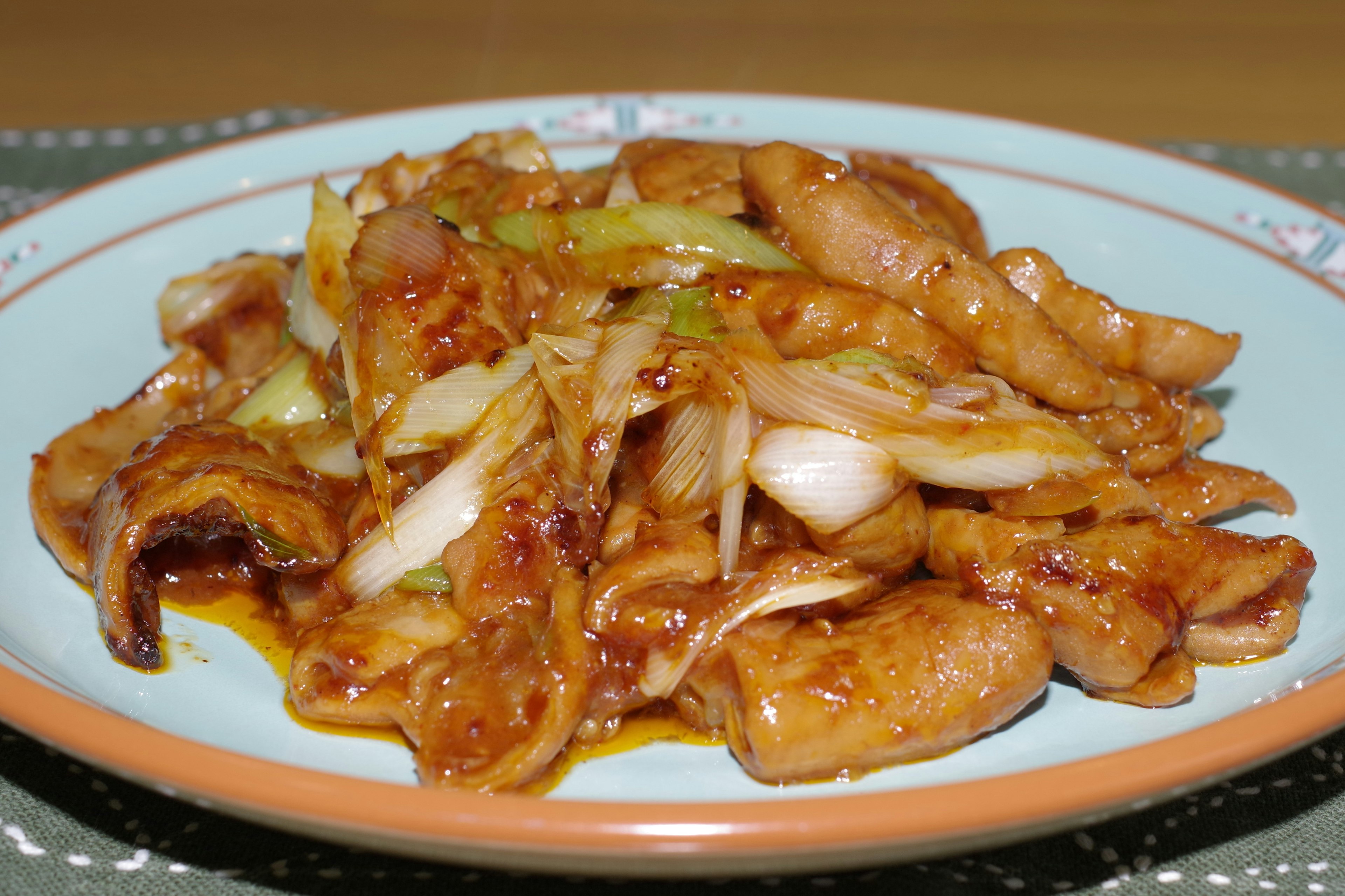 Stir-fried chicken with onions served on a plate