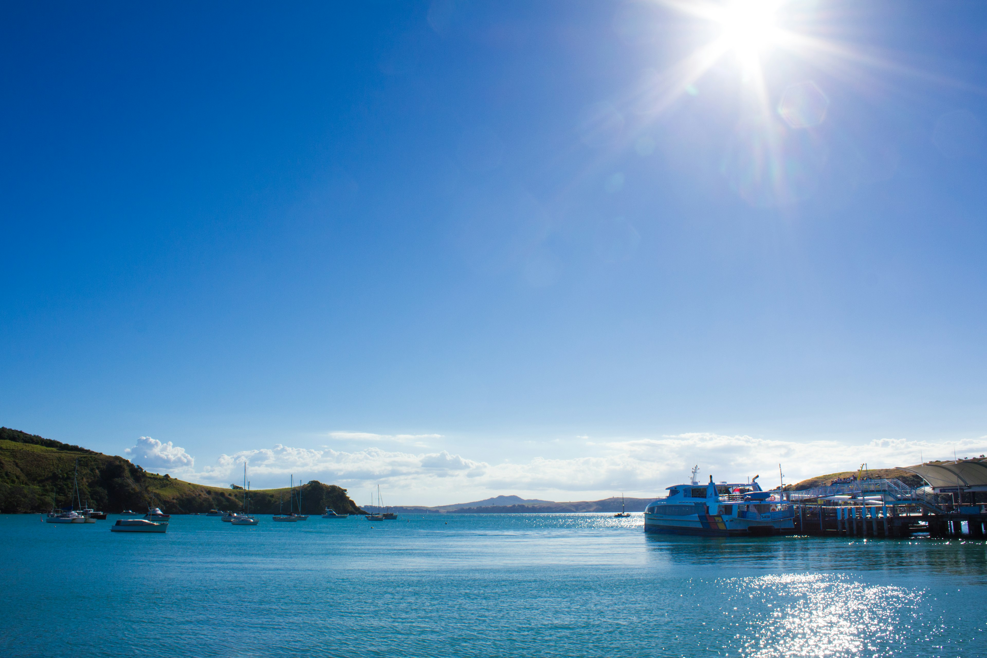 Scenic view of blue ocean and clear sky with a docked boat