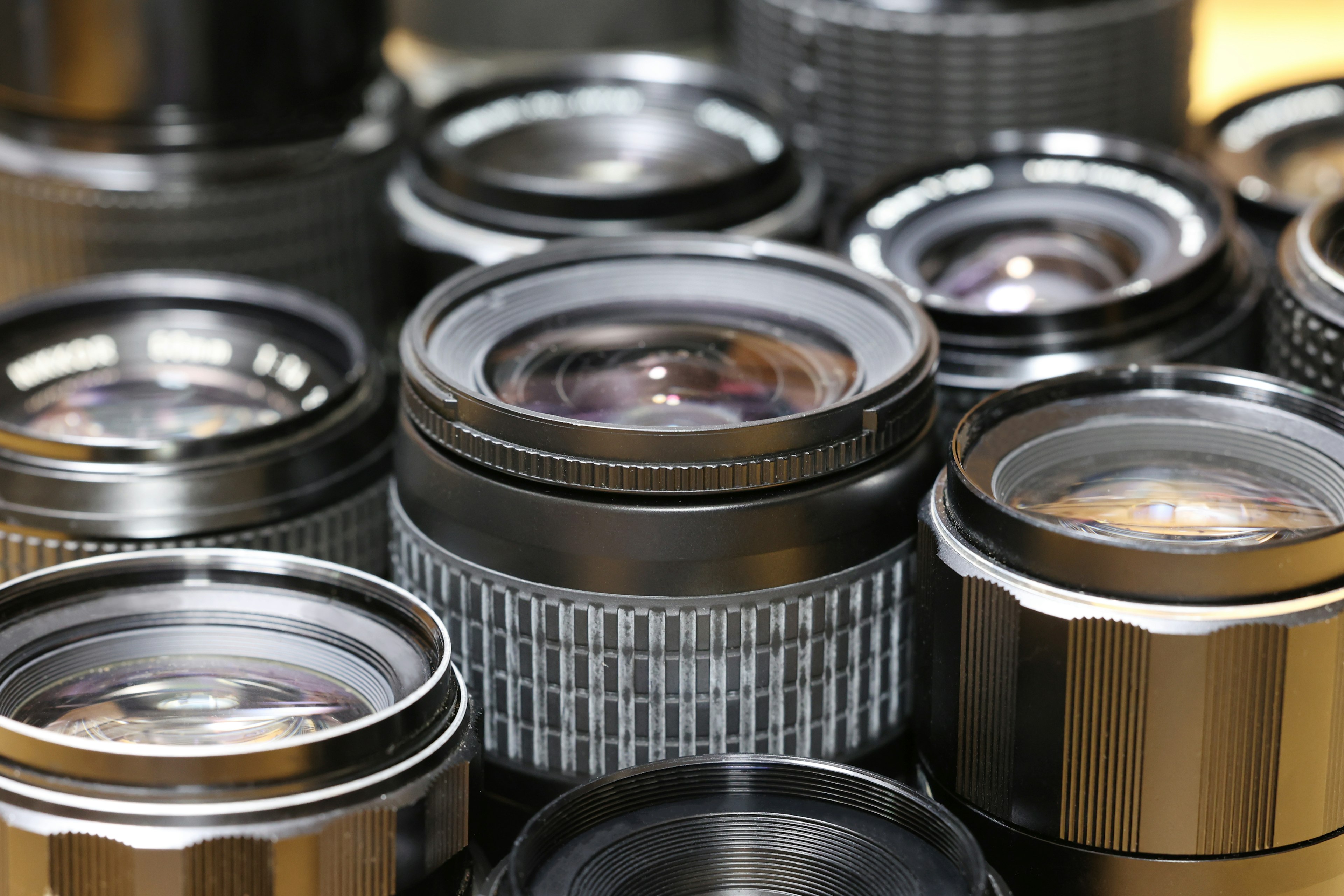 Close-up image of camera lenses arranged in a collection