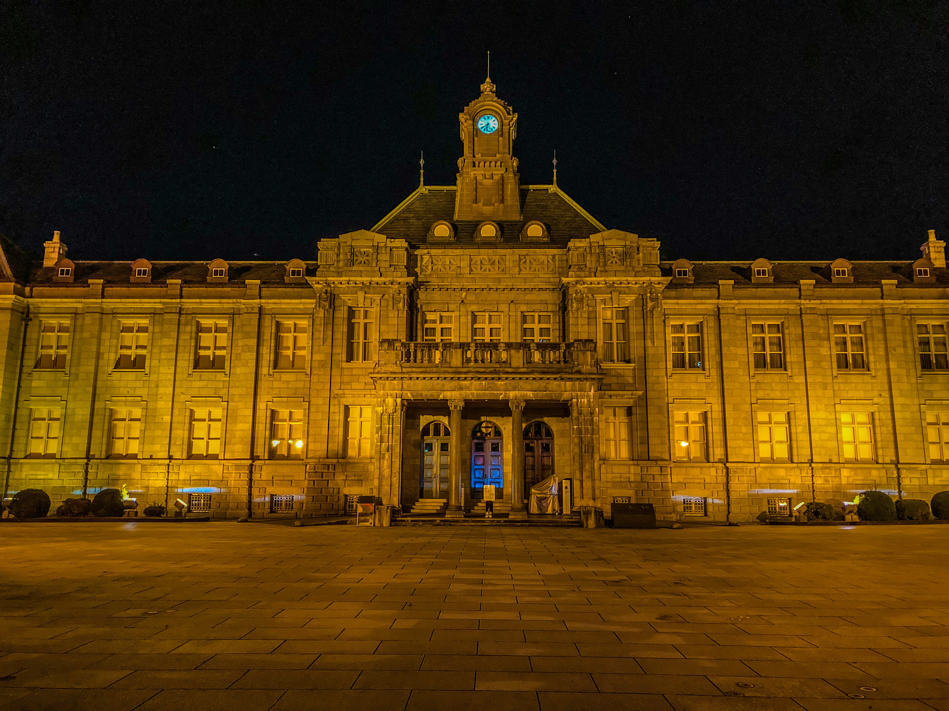 Front view of a beautifully illuminated historic building at night