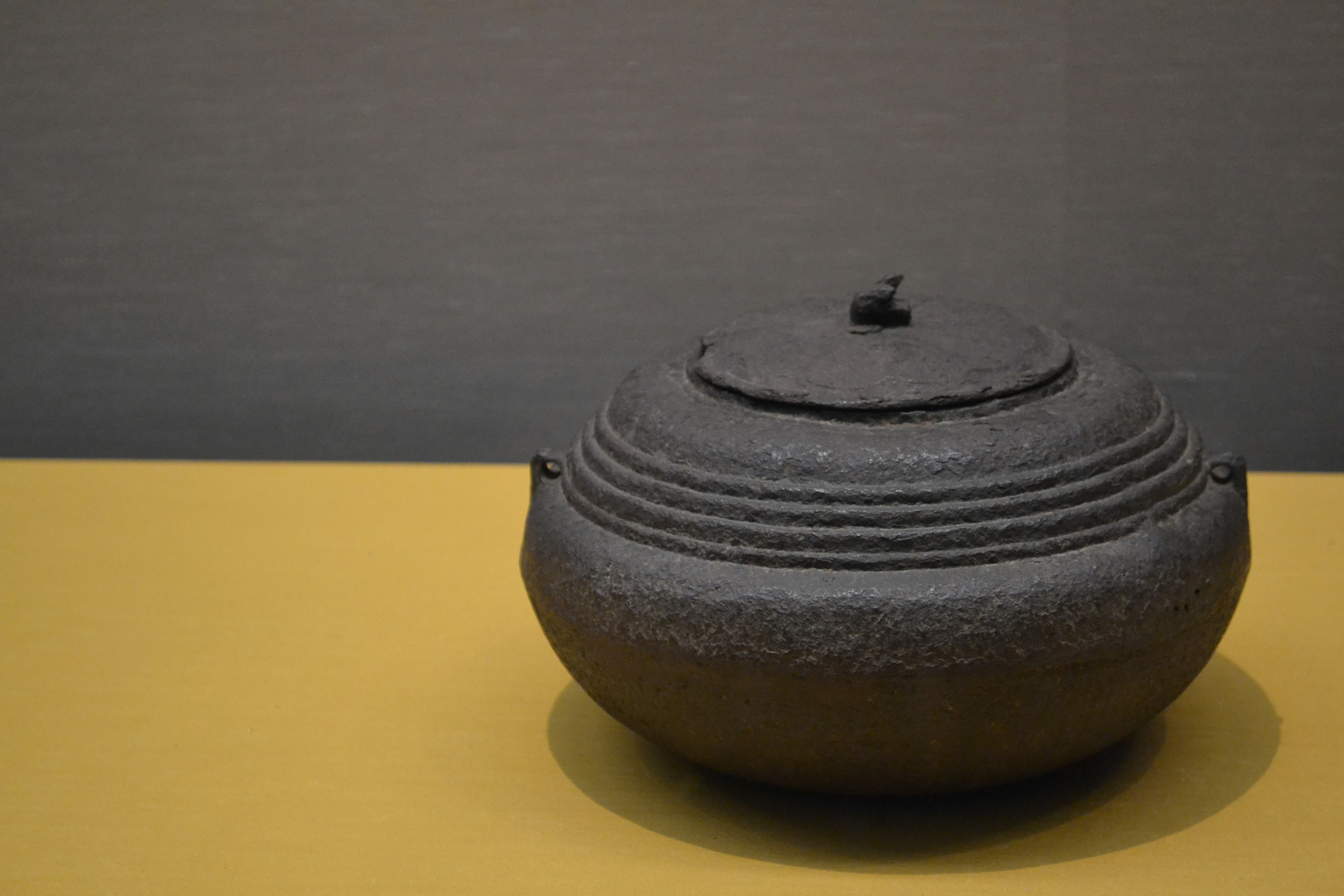 Black cast iron vessel on a yellow table