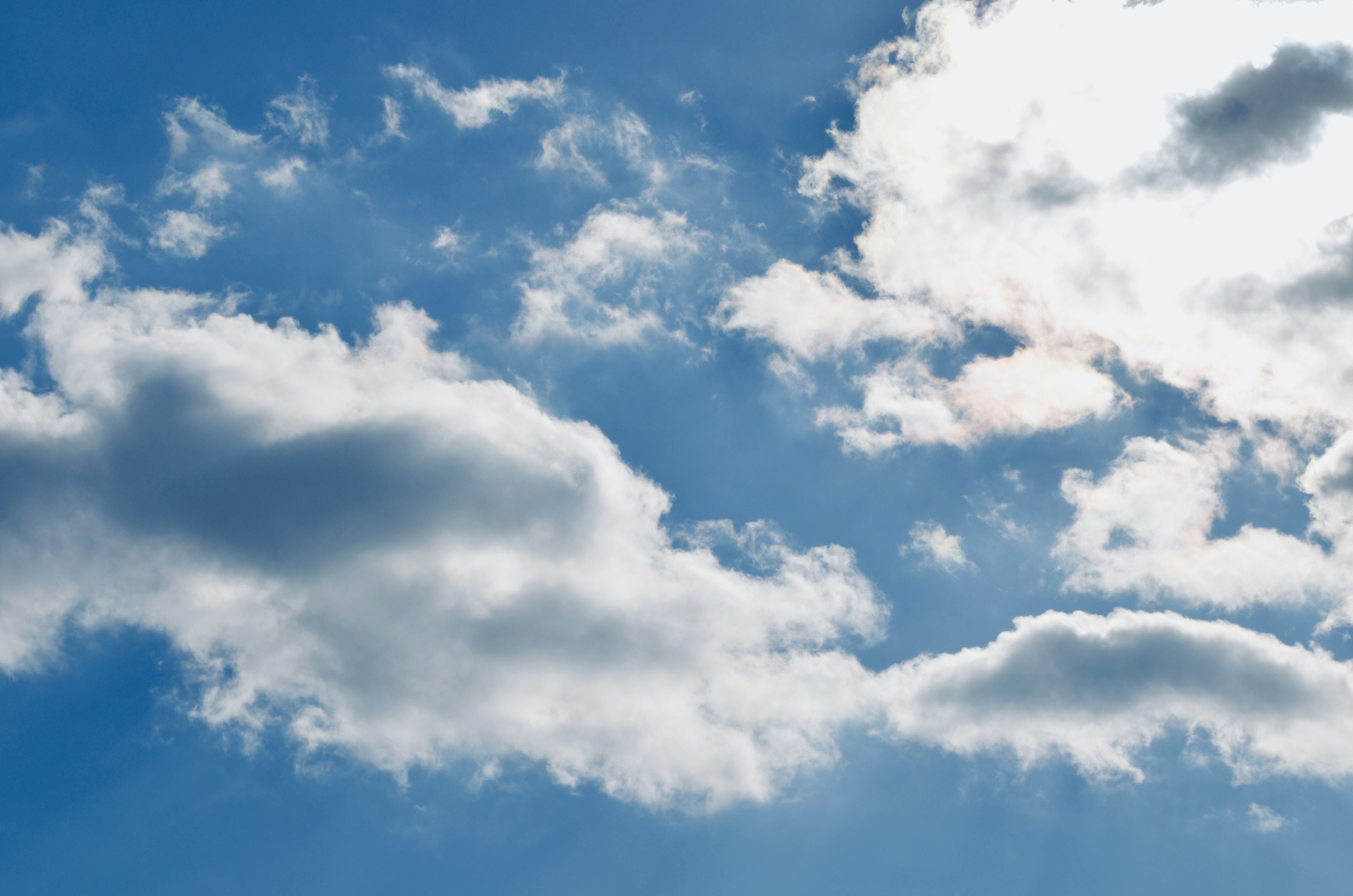 A scenic view of white clouds floating in a blue sky