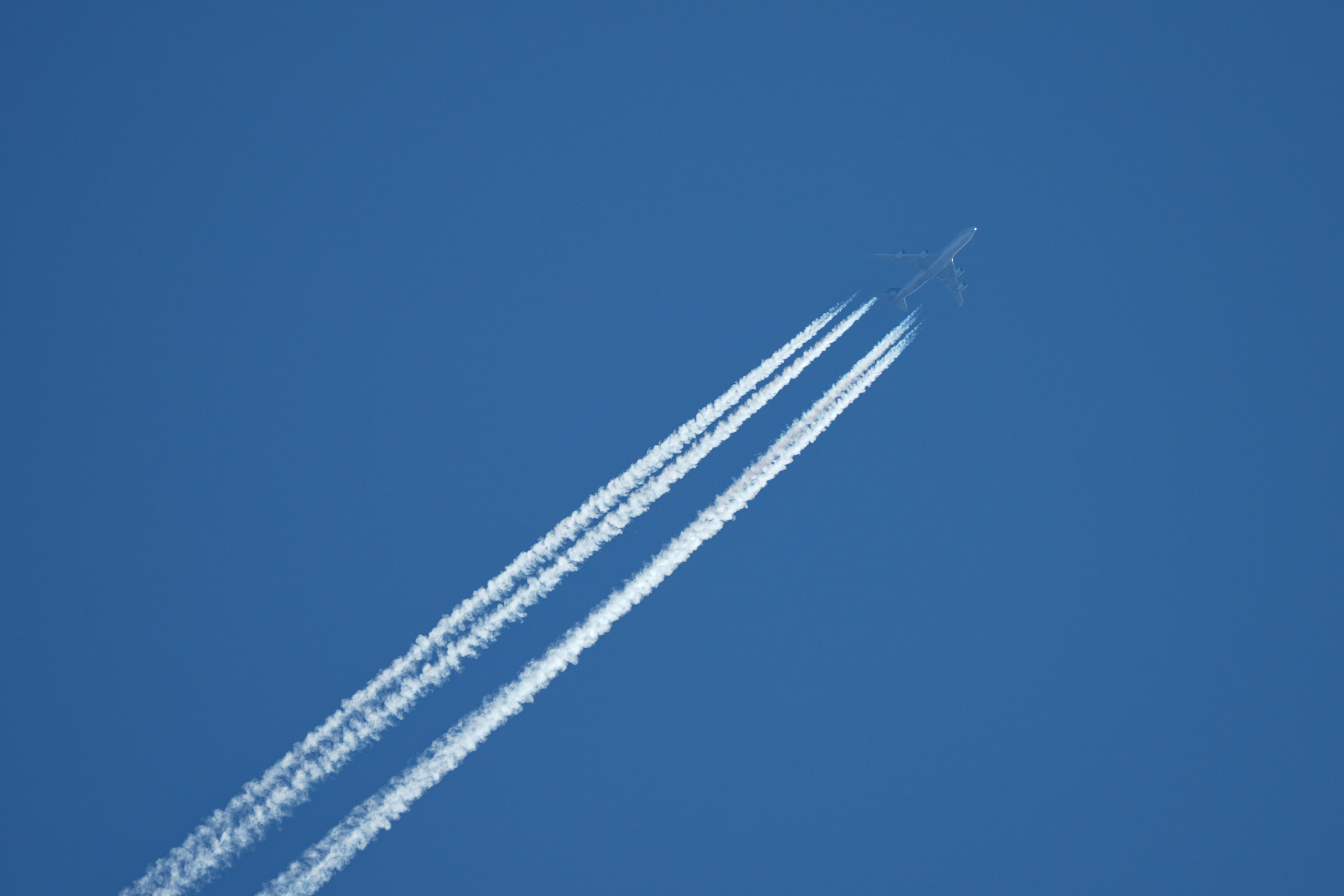 Airplane contrails visible in a clear blue sky