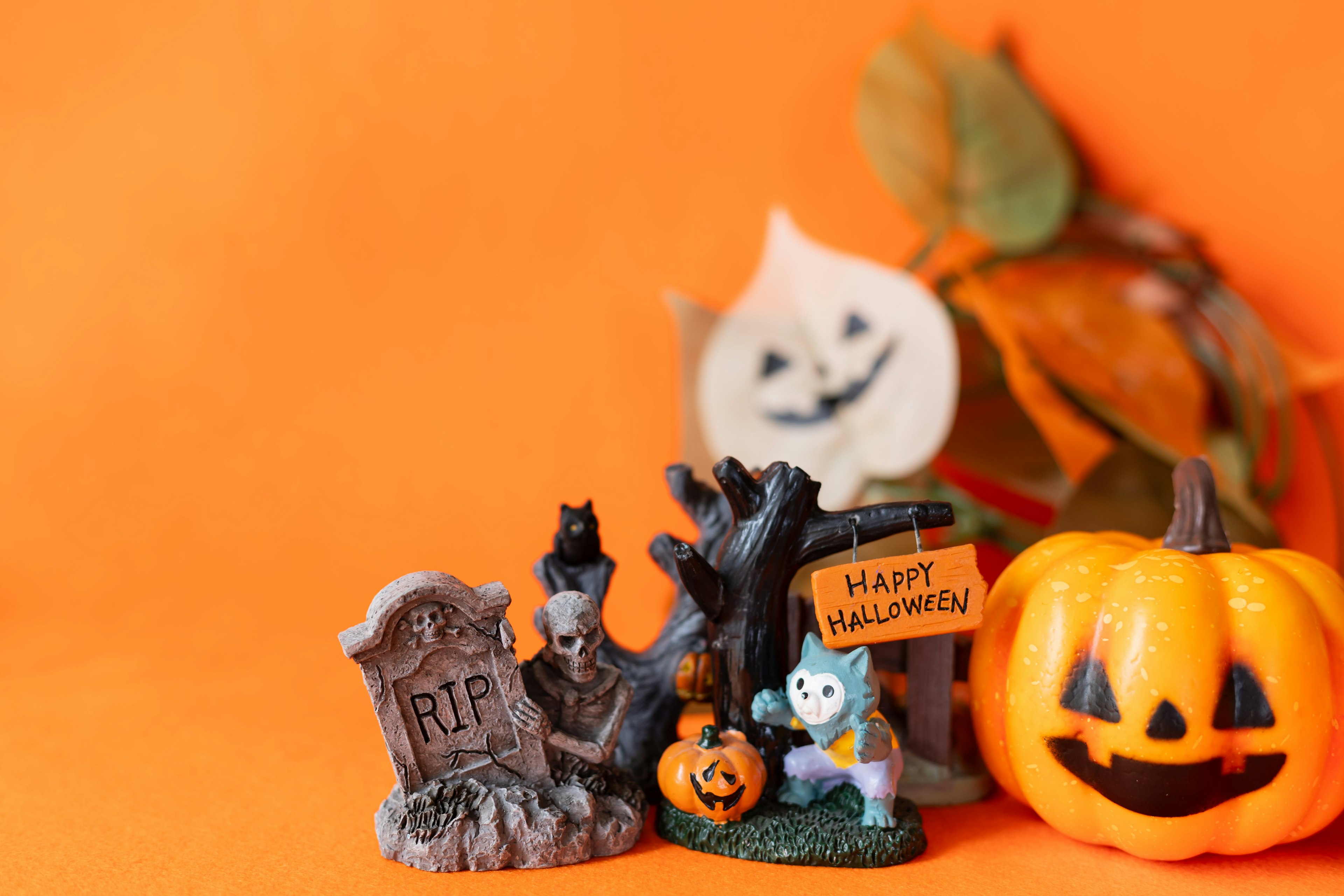 Halloween decorations featuring toy figures on an orange background