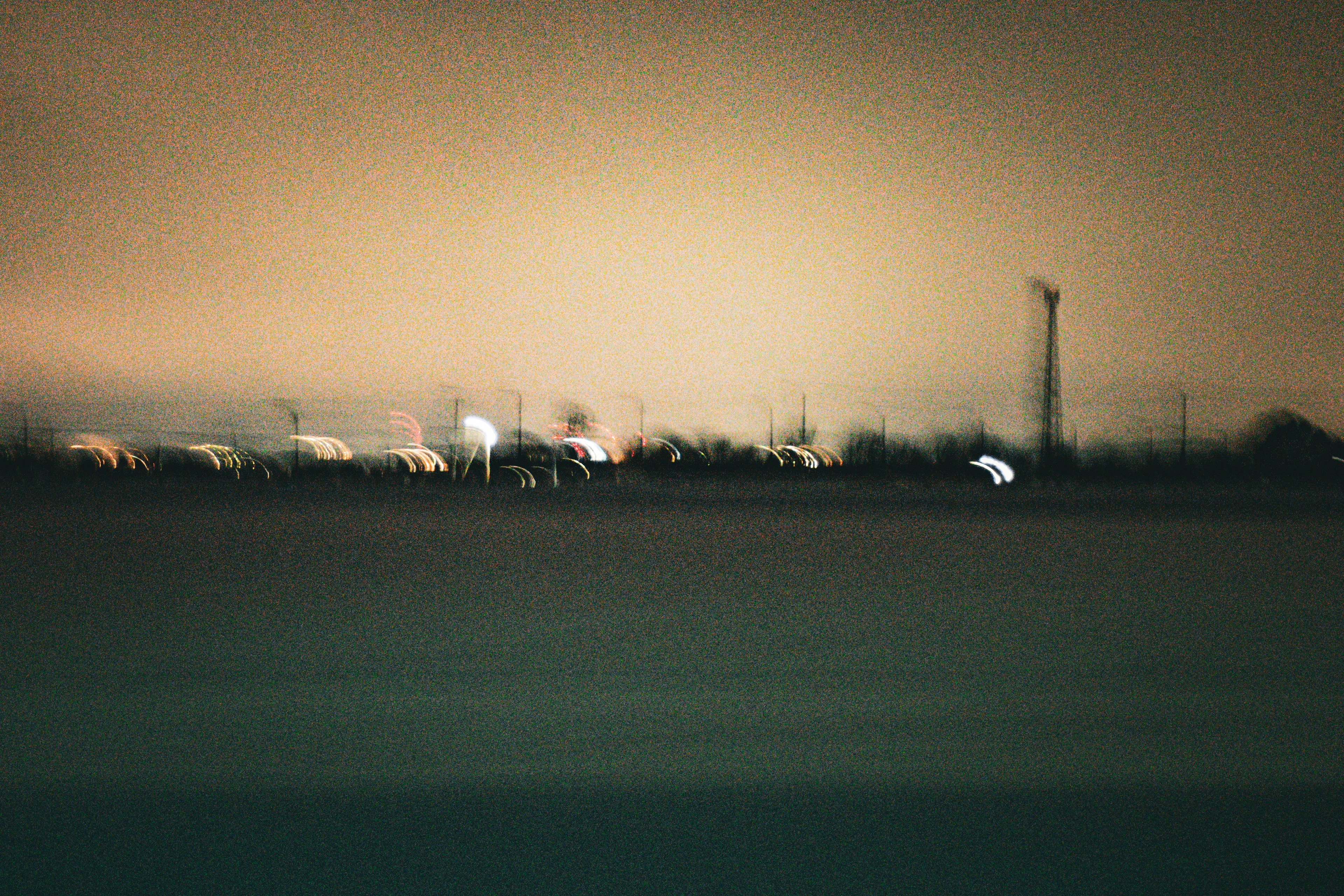 Blurred night landscape with distant lights and soft colors