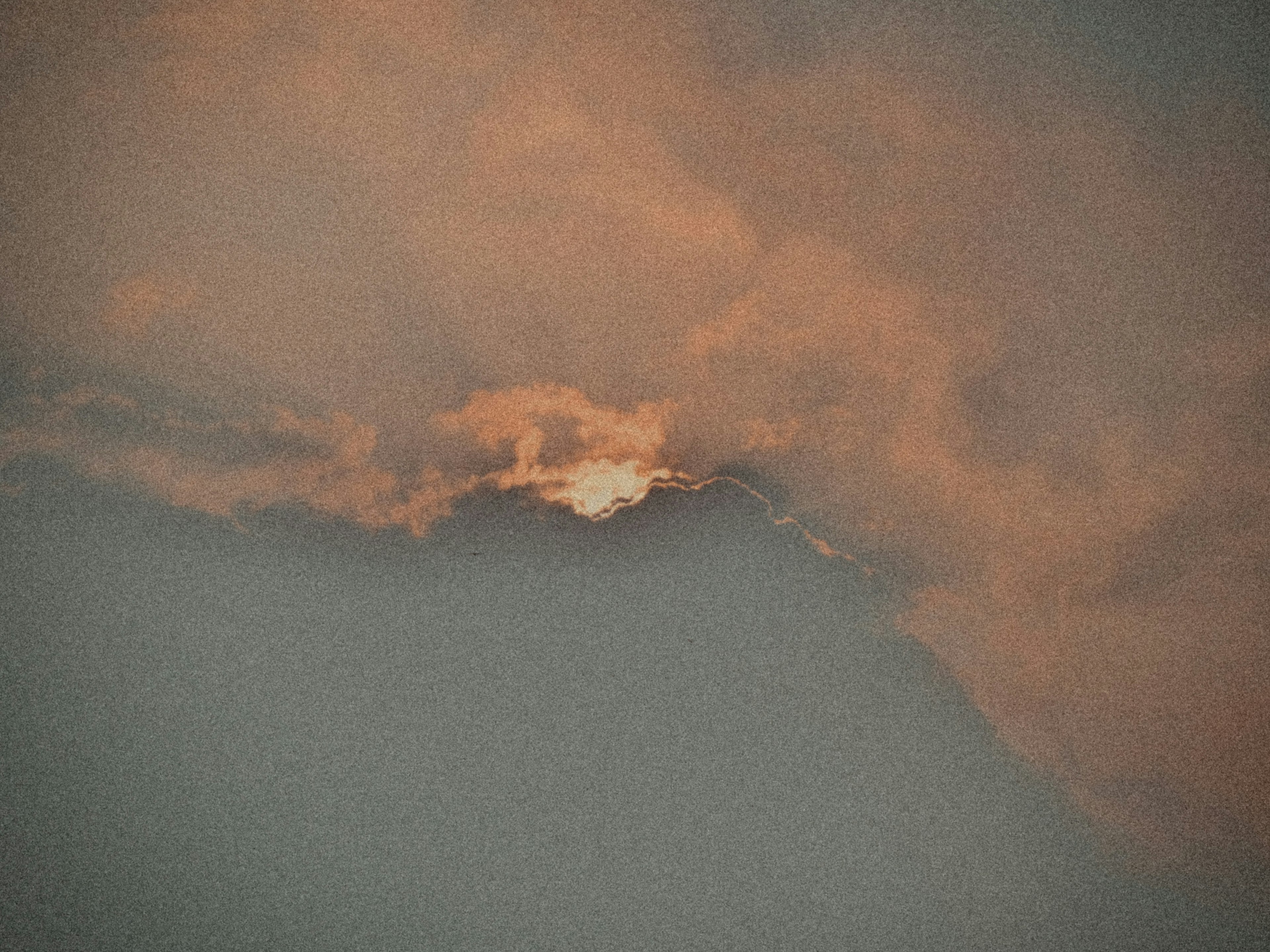 Impressive sky view with orange sunset visible through clouds