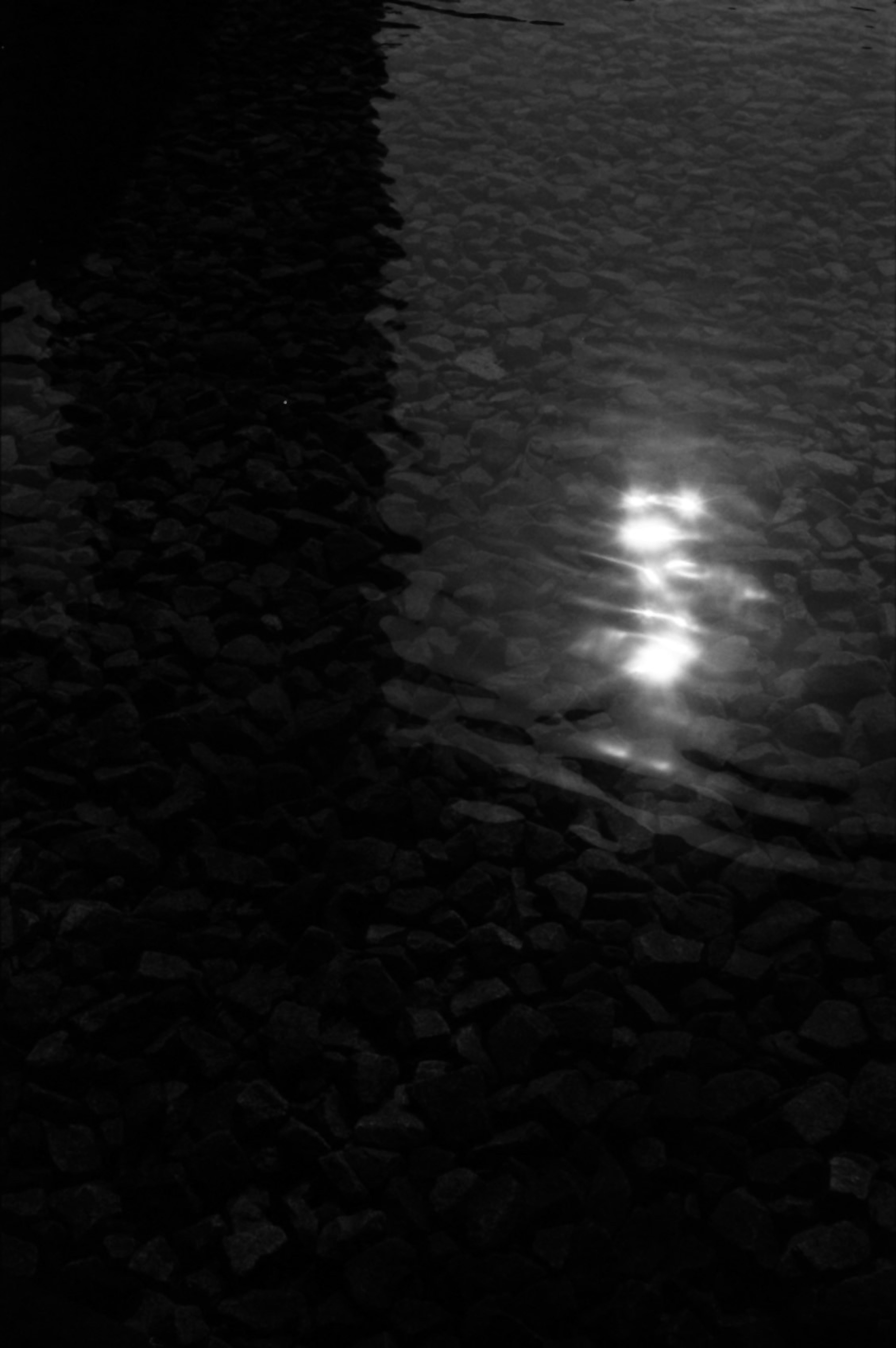 Reflection of light on water surface with dark background