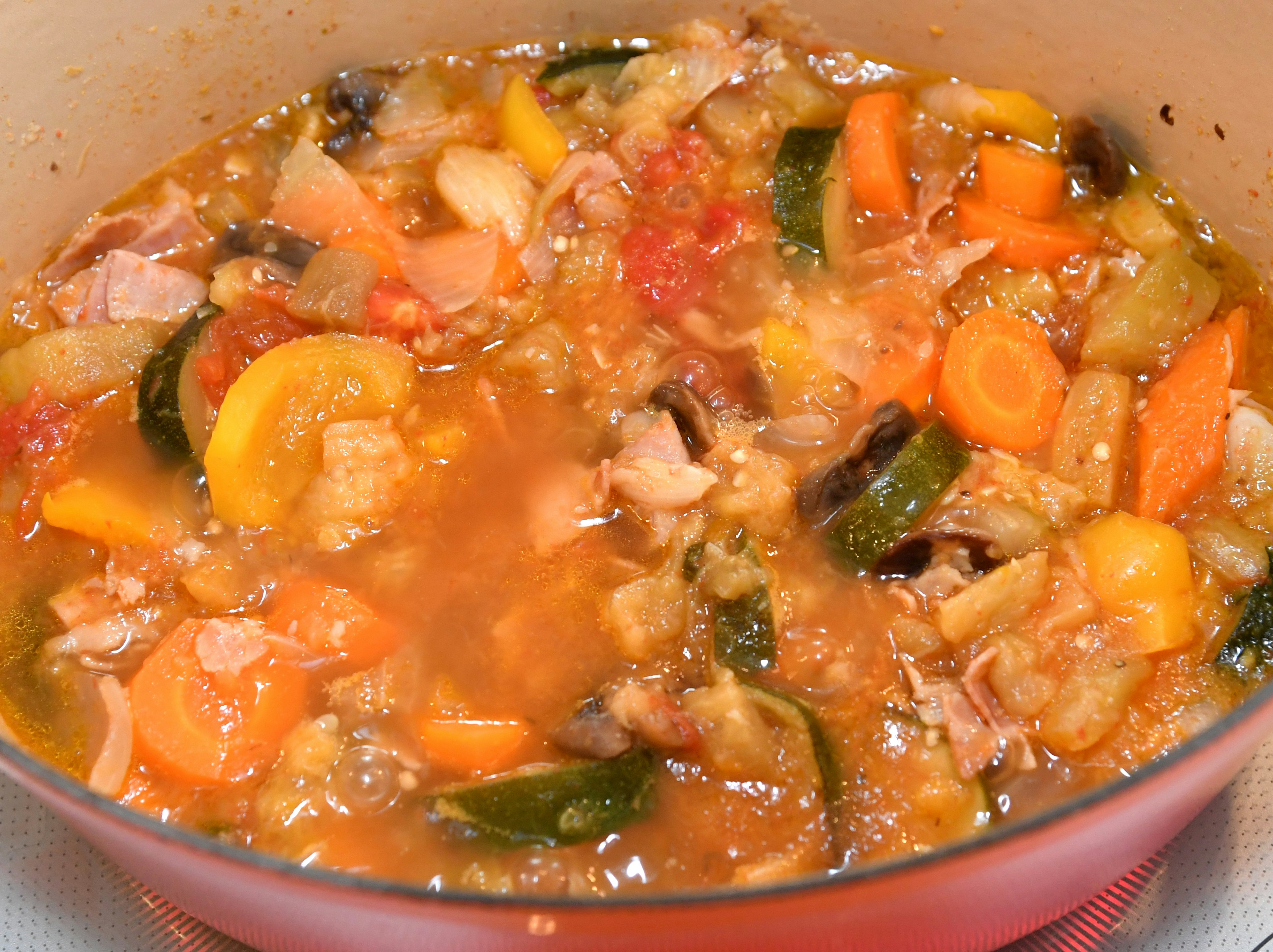 A colorful stew with vegetables and meat simmering in a pot