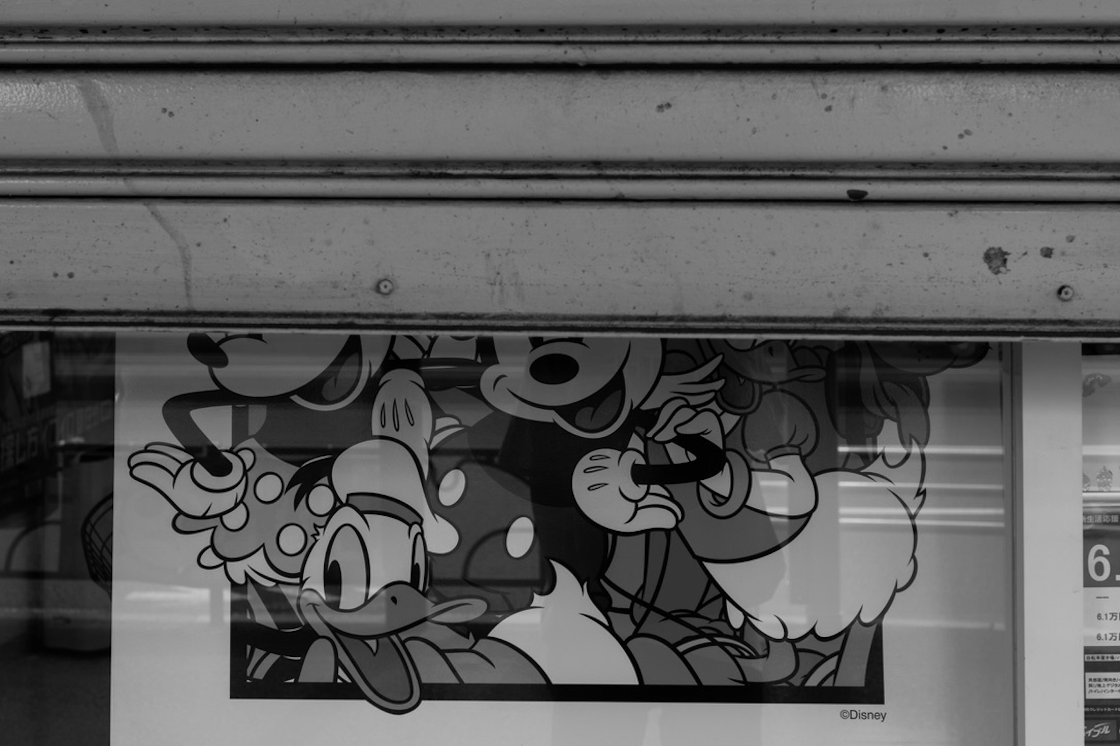 Close-up of a black and white poster featuring cartoon characters