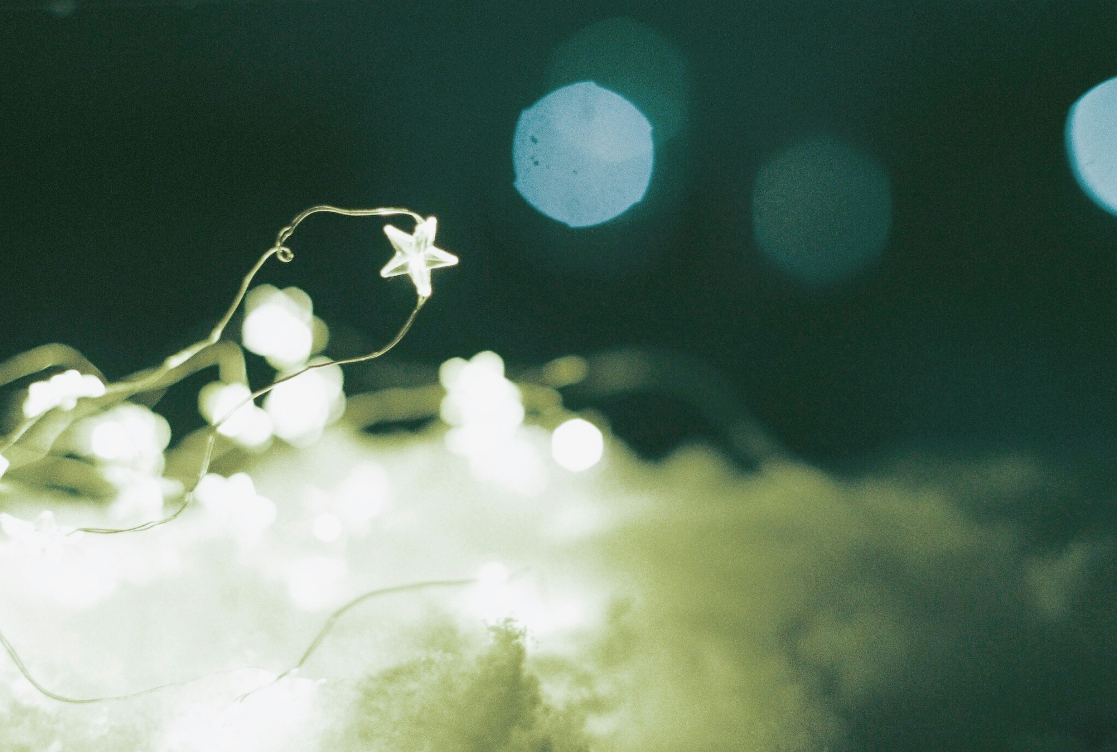 A whimsical image featuring star-shaped lights against a dark background