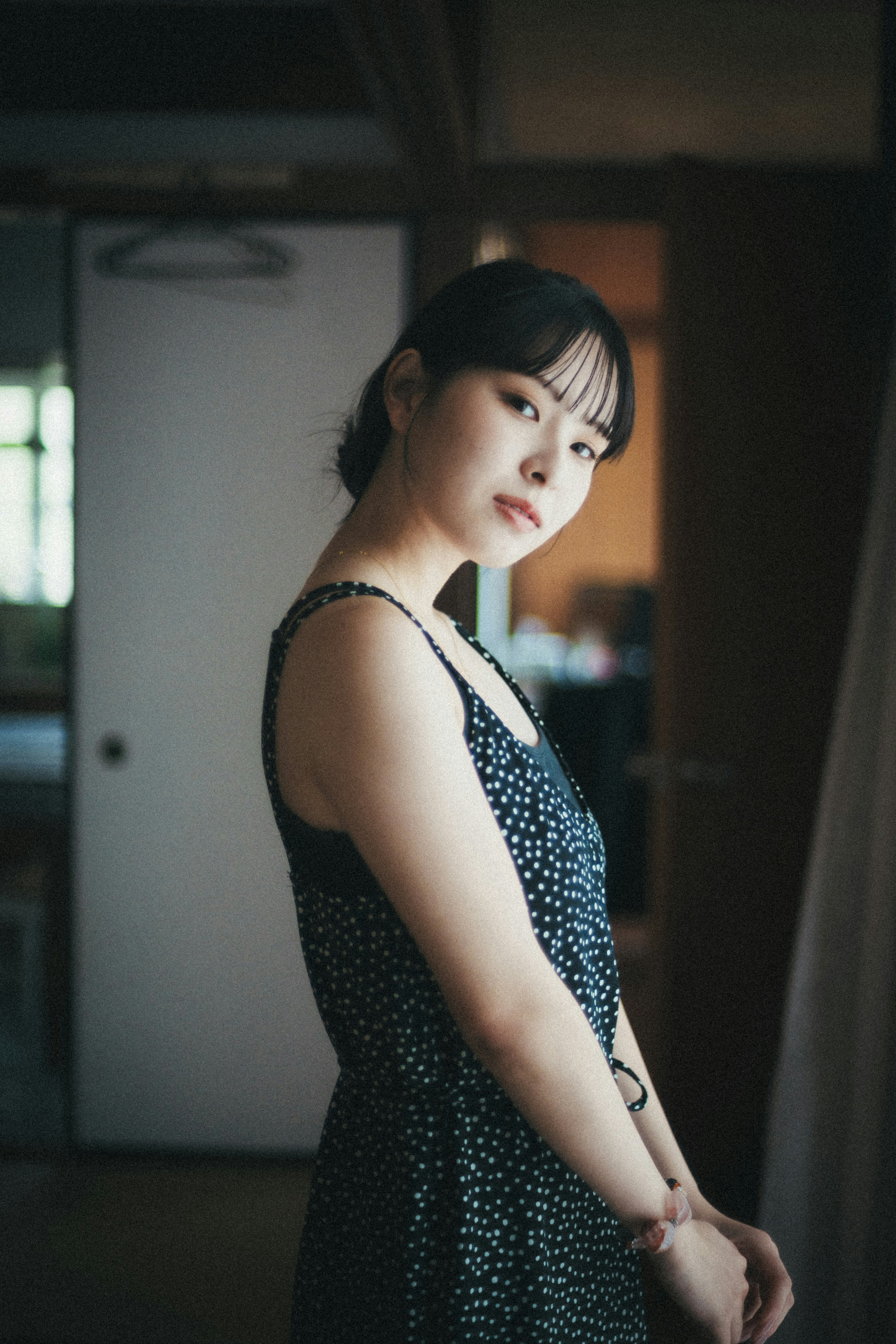 A woman posing in an artistic indoor setting