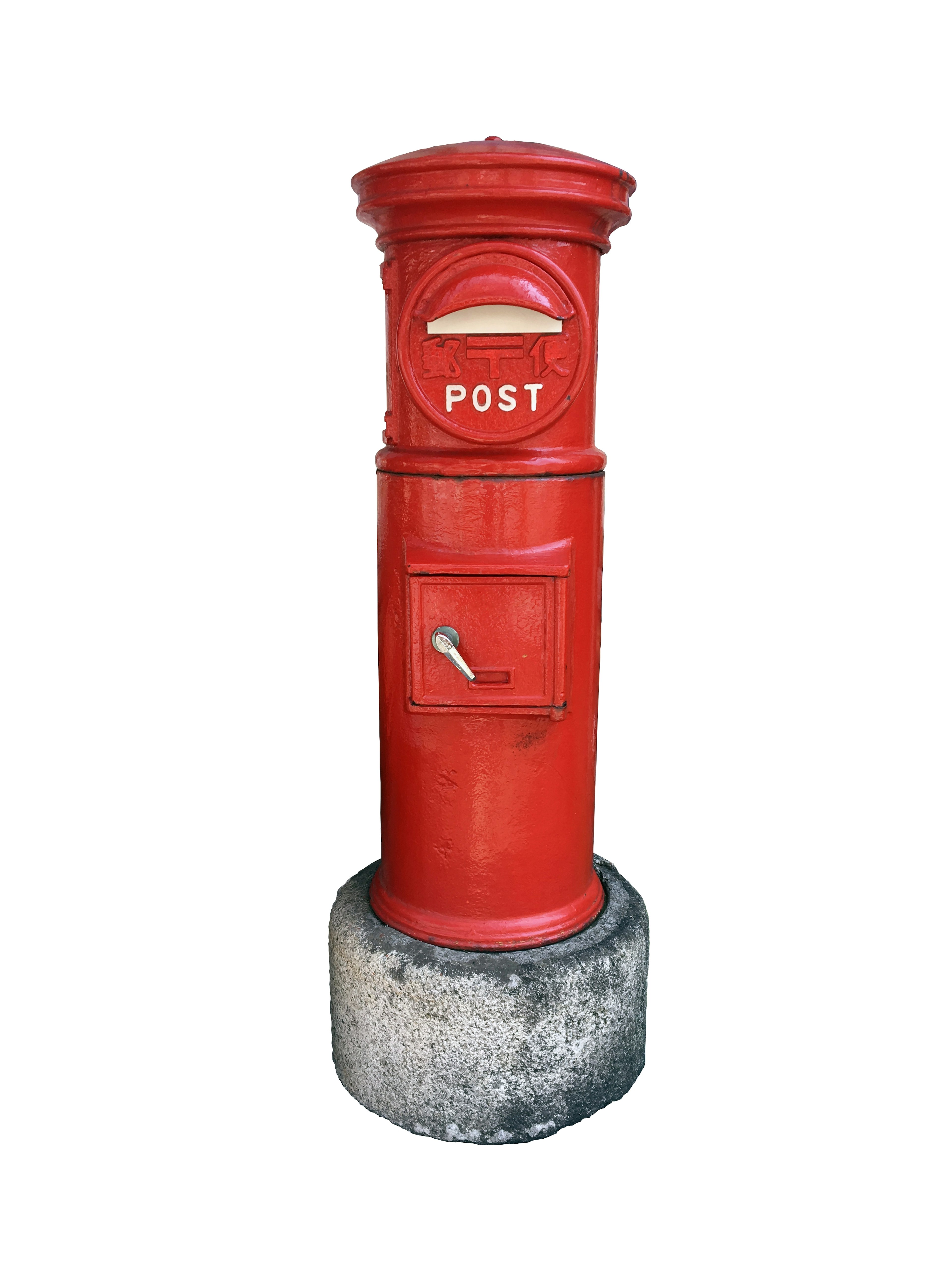 A distinctive red post box with a round top