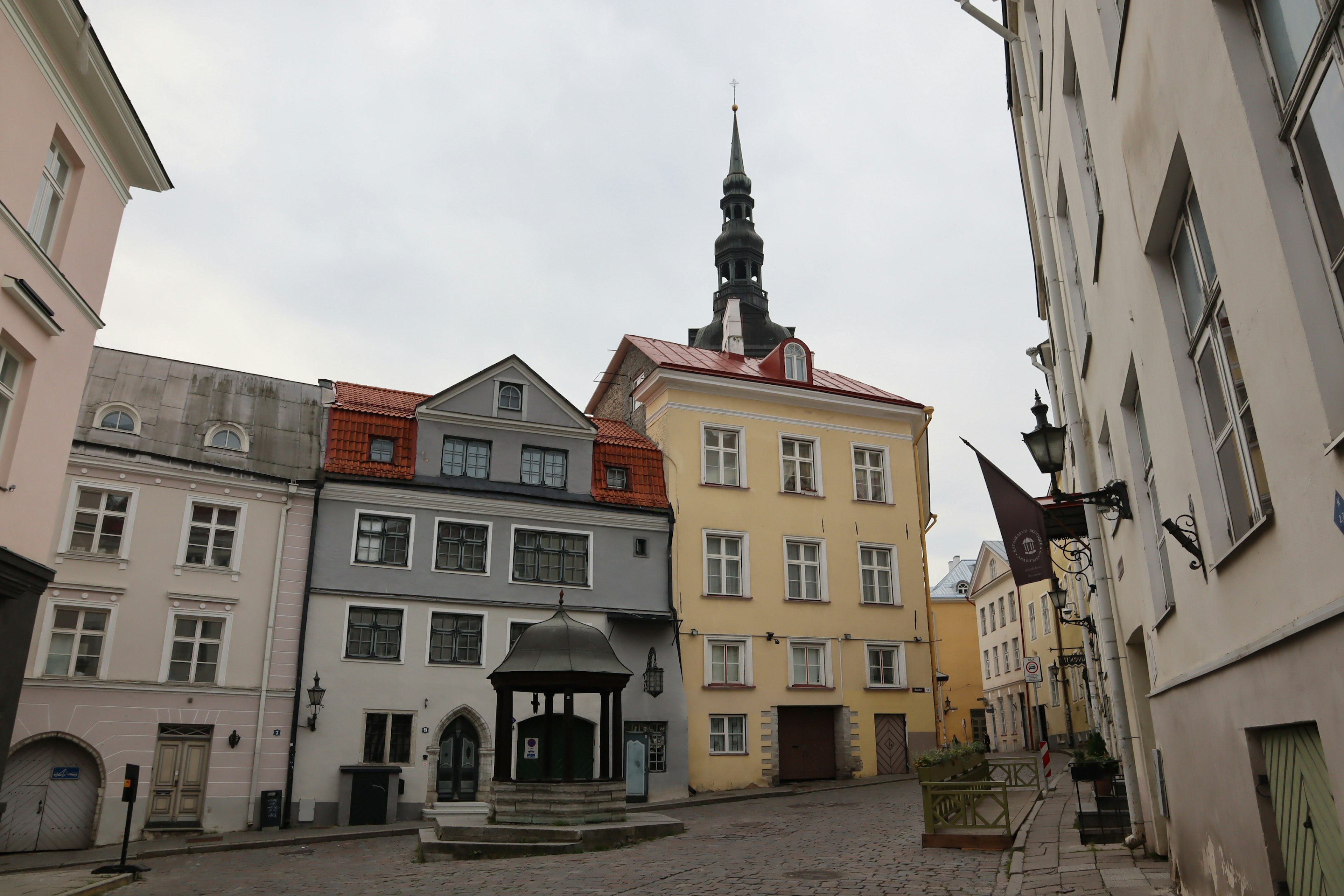 Quiet street corner with old buildings and a church spire