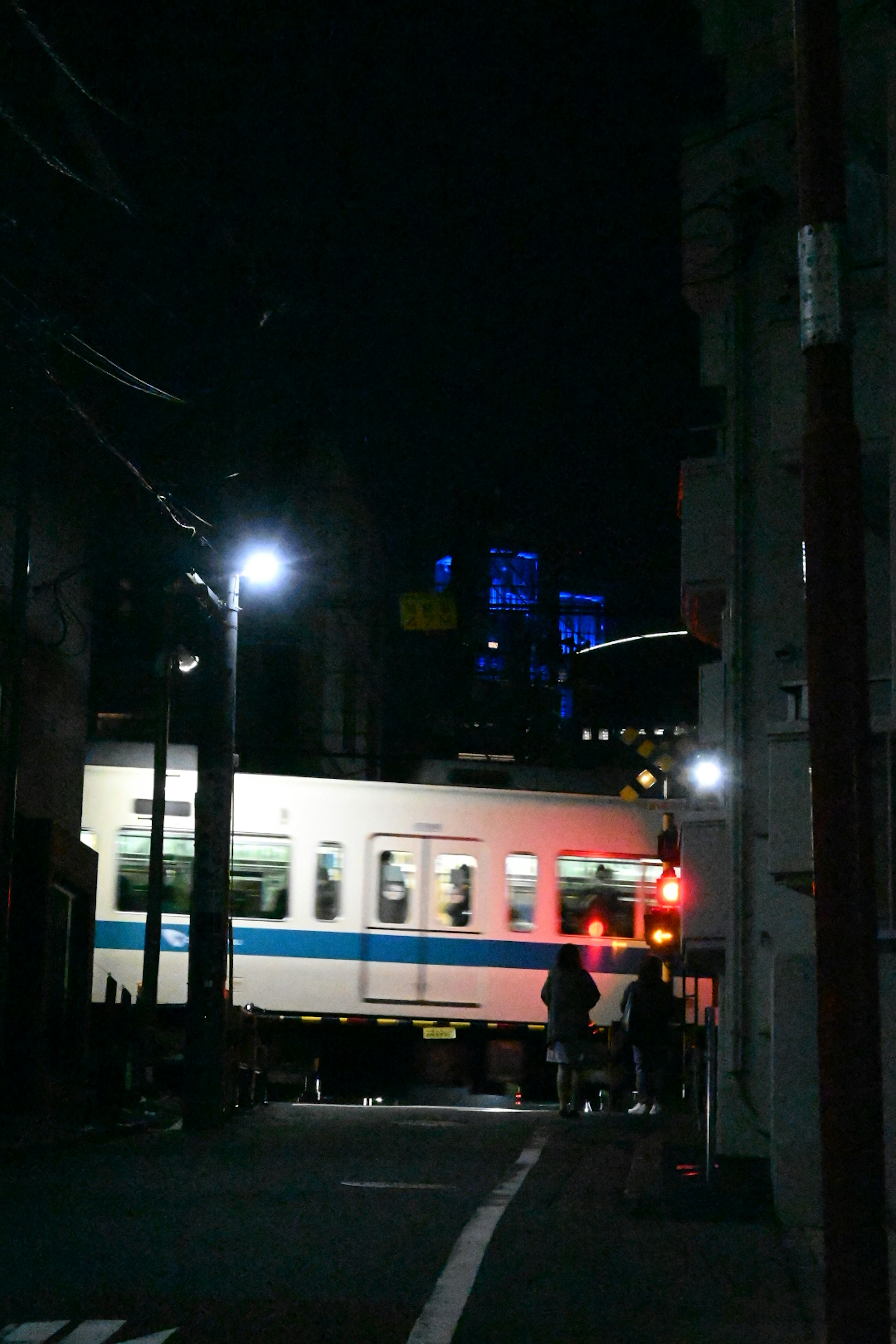 Train passing through a dark street with city lights