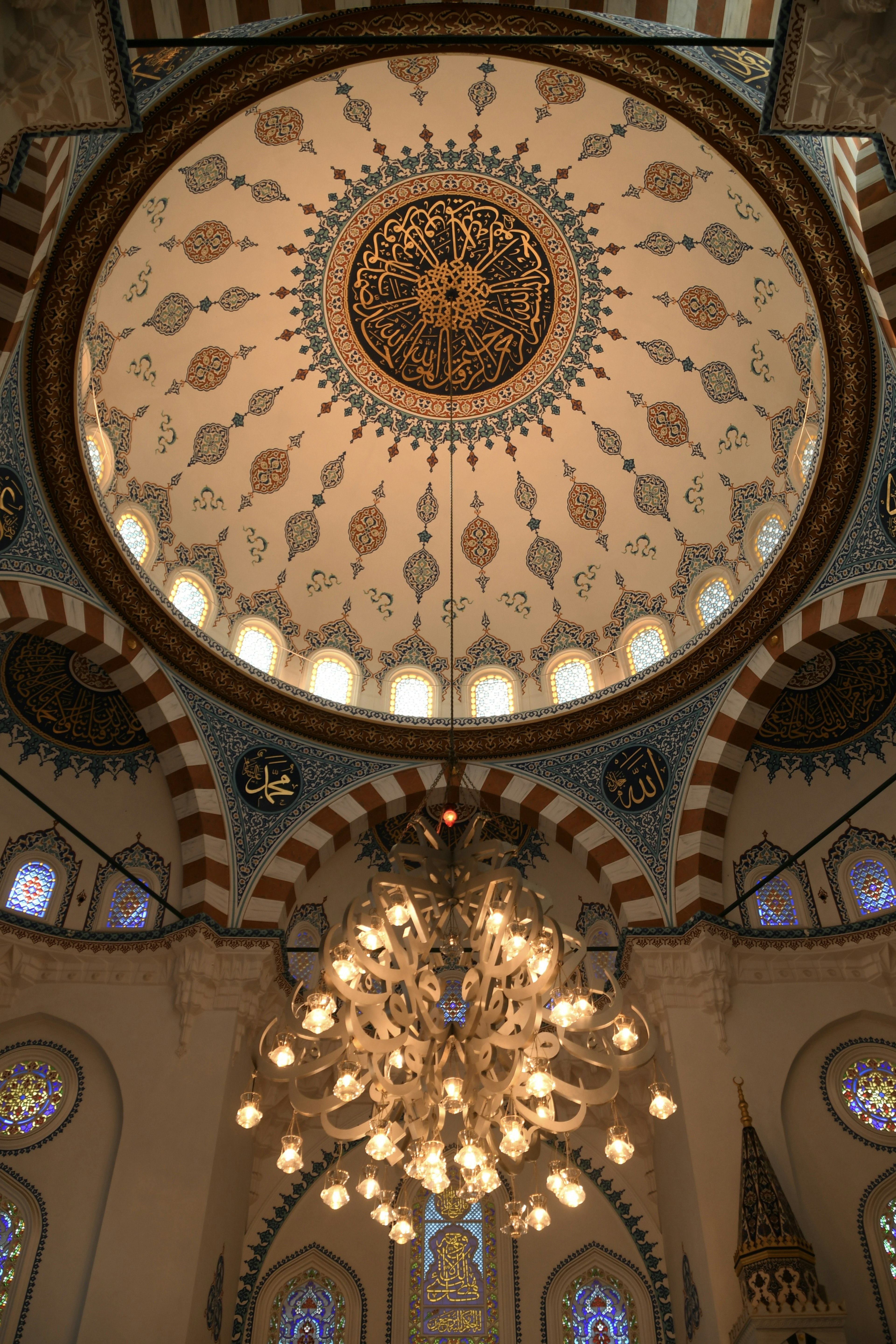 Interior view of a building featuring a stunning dome and chandelier