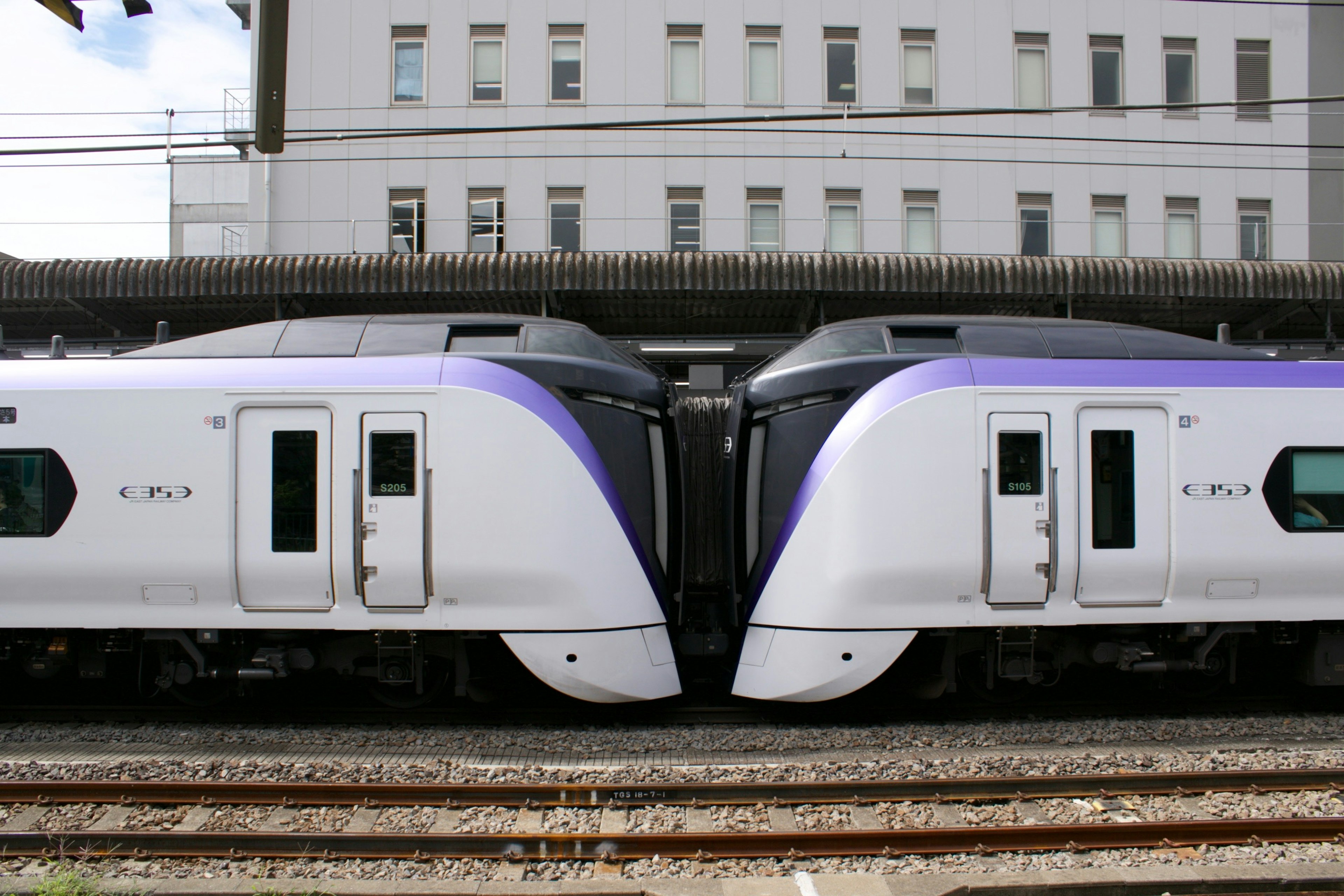 Two trains approaching each other at a station