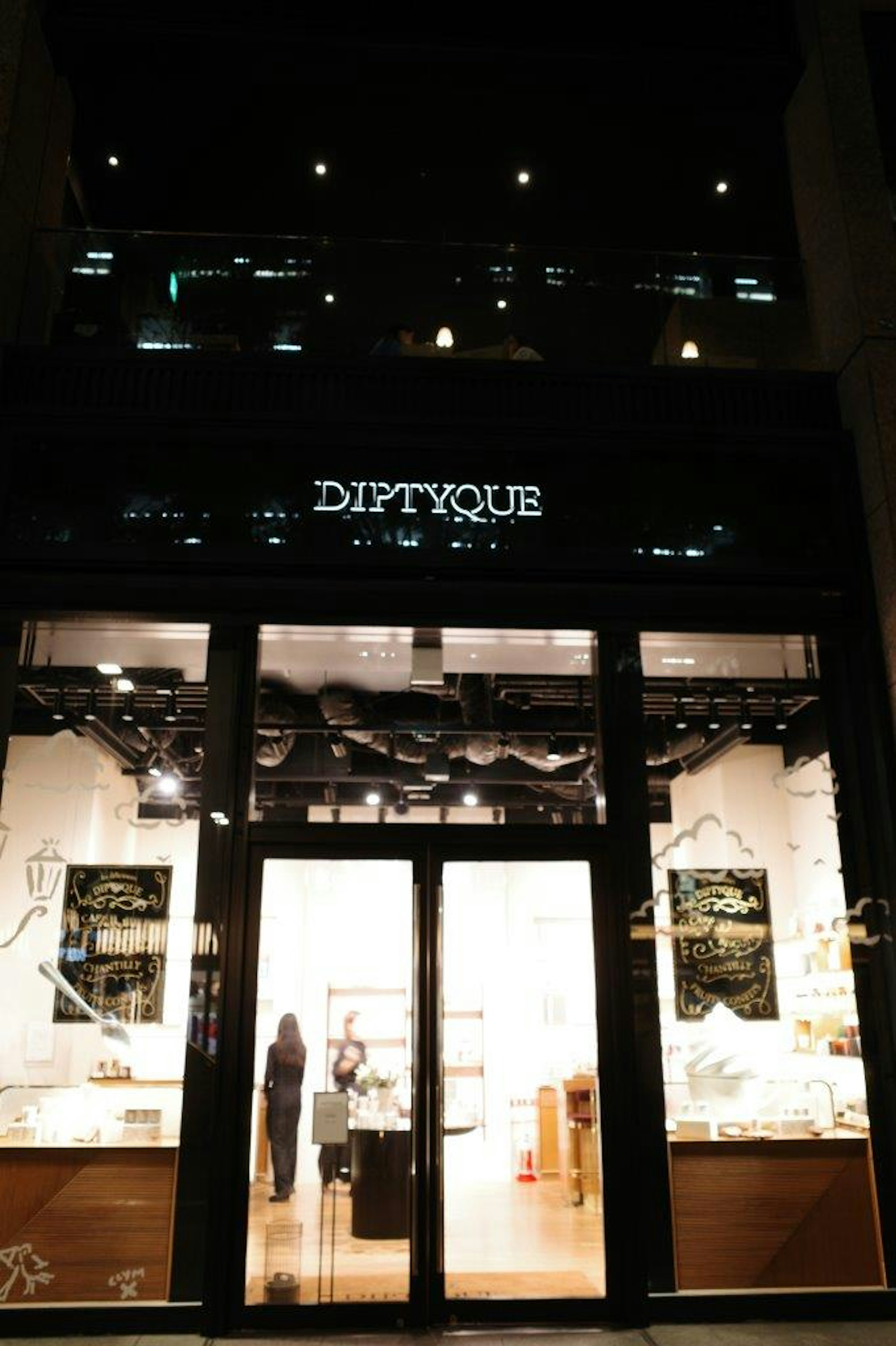 Diptyque store exterior featuring bright lighting and elegant design