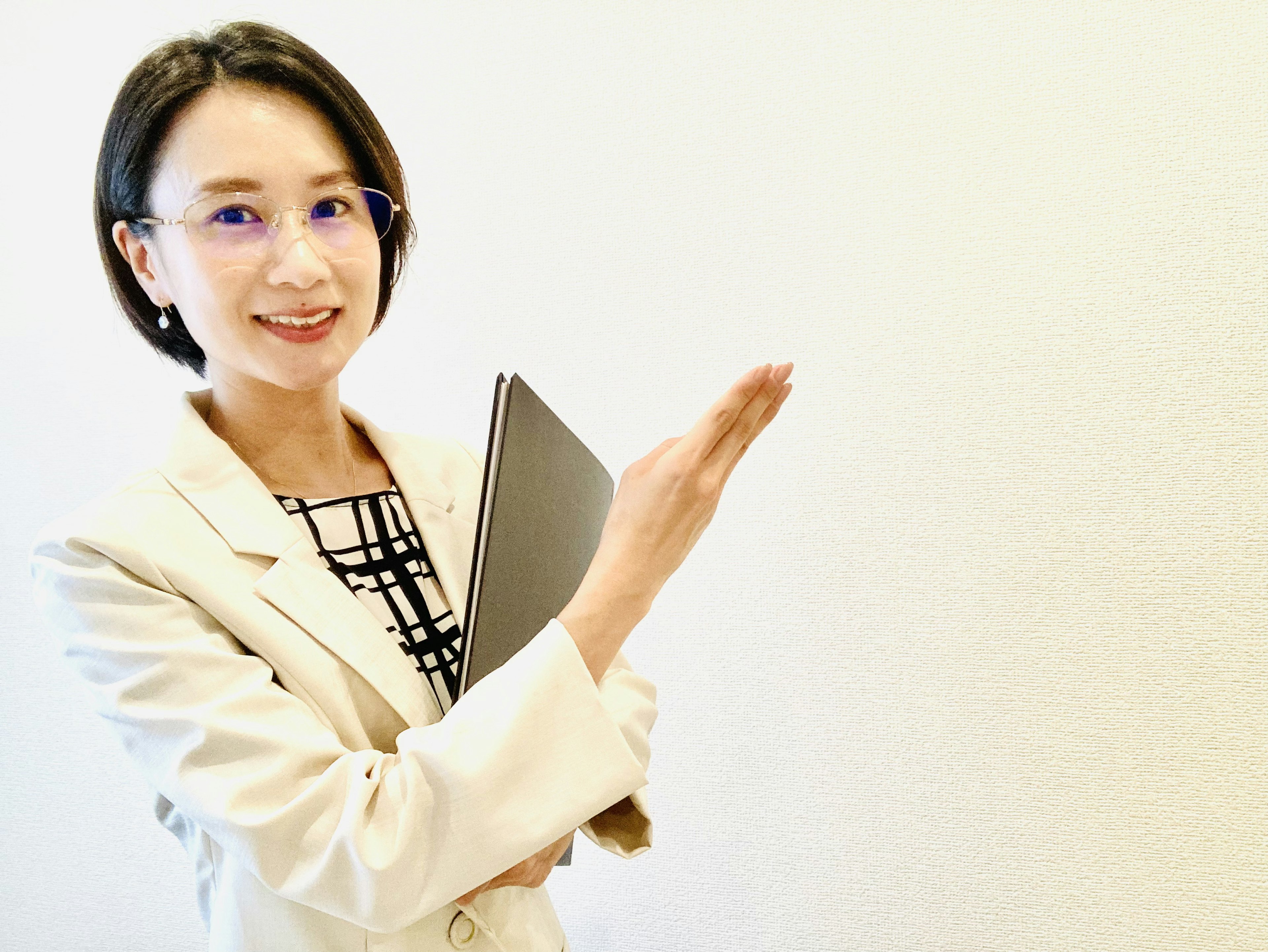 A businesswoman in a suit extending her hand