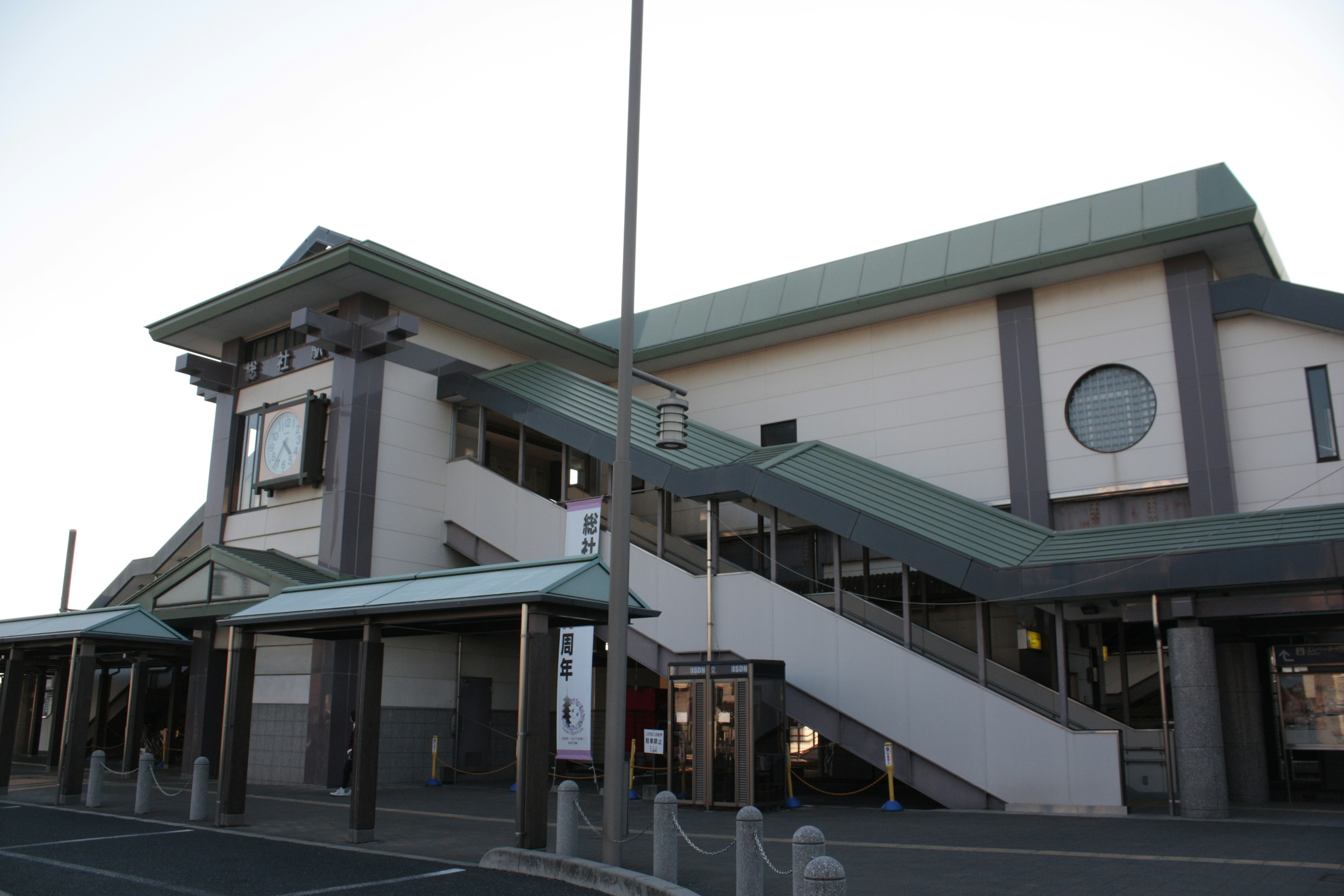 Exterior view of a modern train station featuring stairs and architectural details