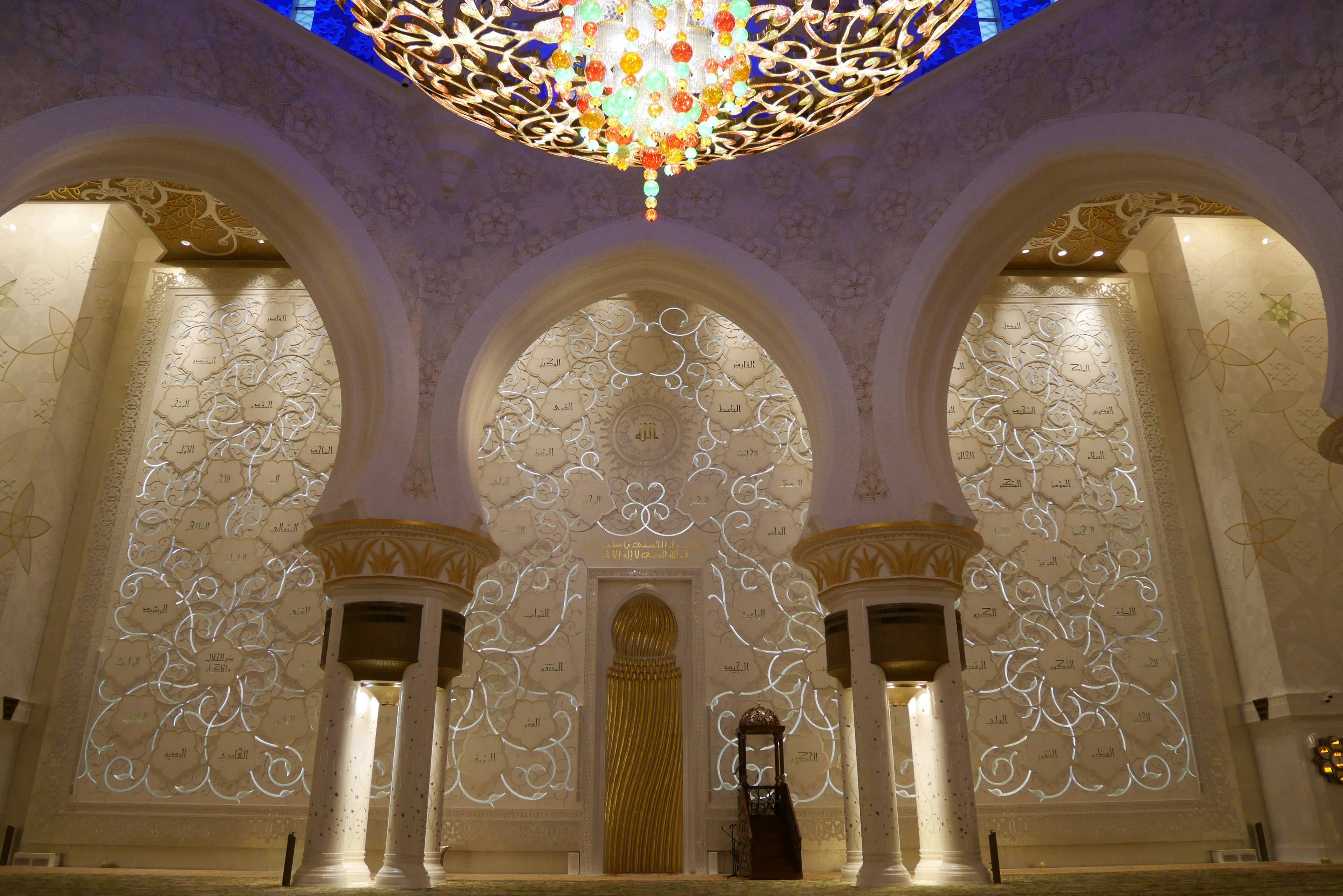 Interior space featuring beautiful arches and an ornate chandelier