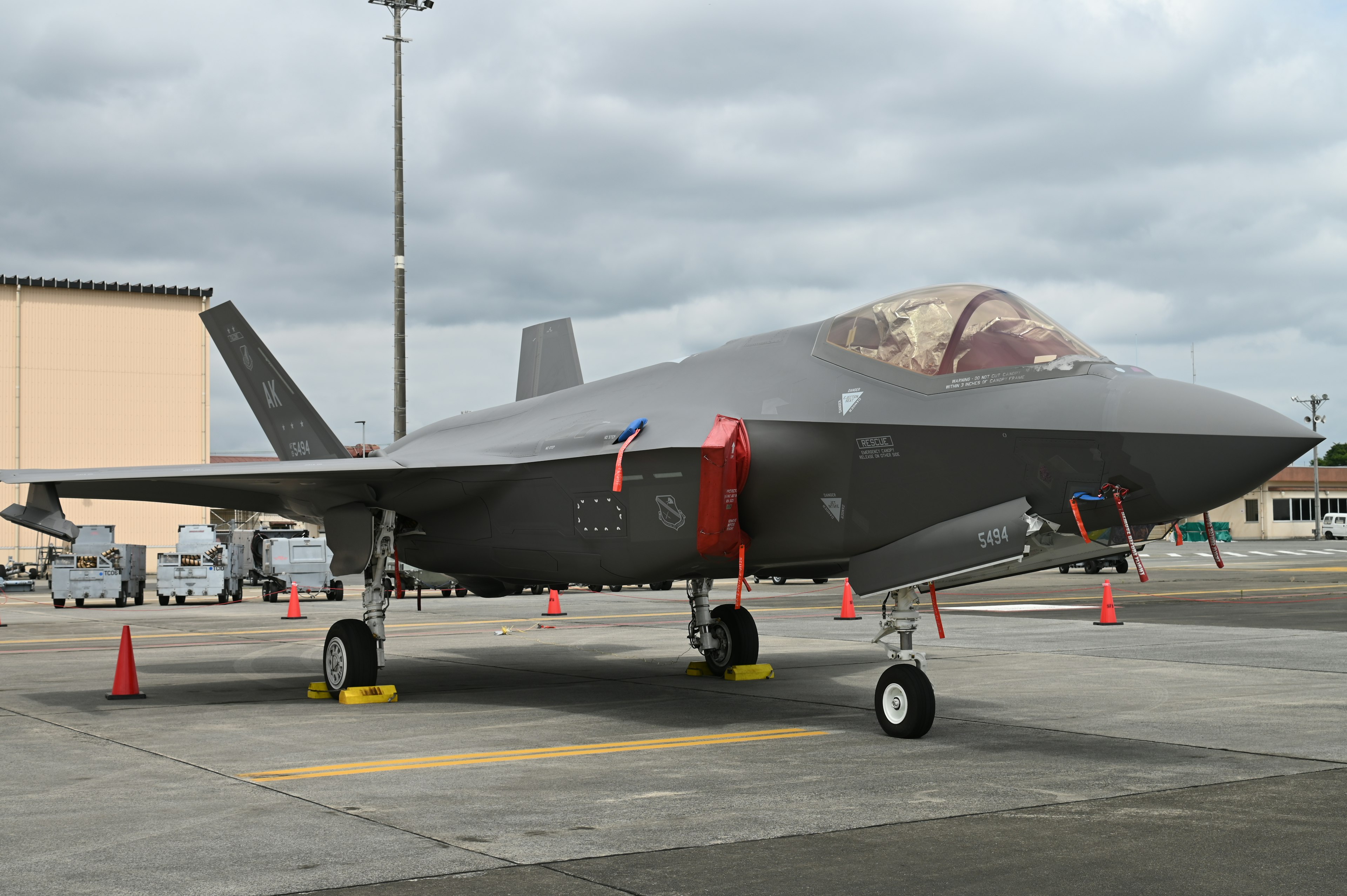 A modern fighter jet parked on a runway with a sleek design