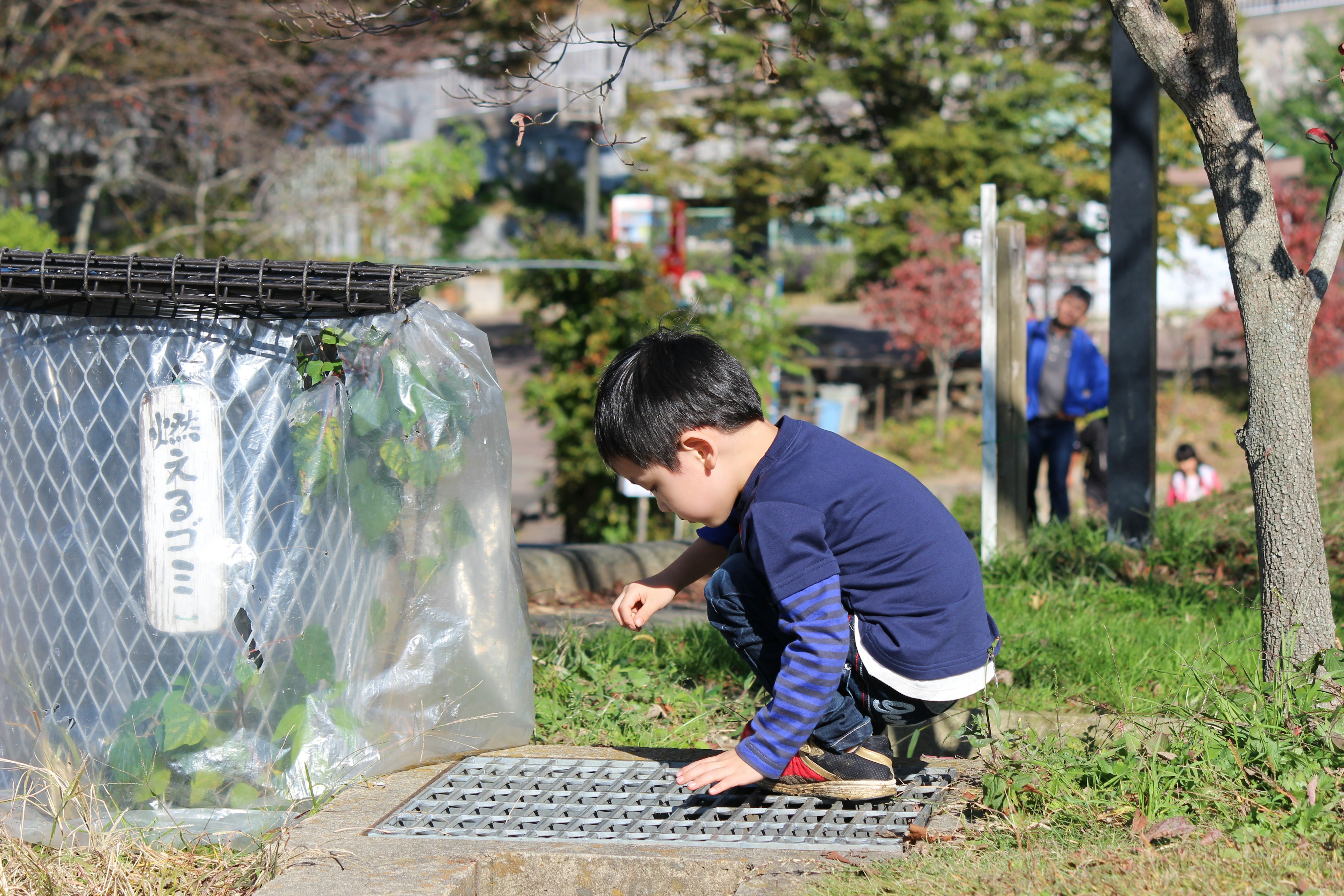 A boy exploring the ground in a park