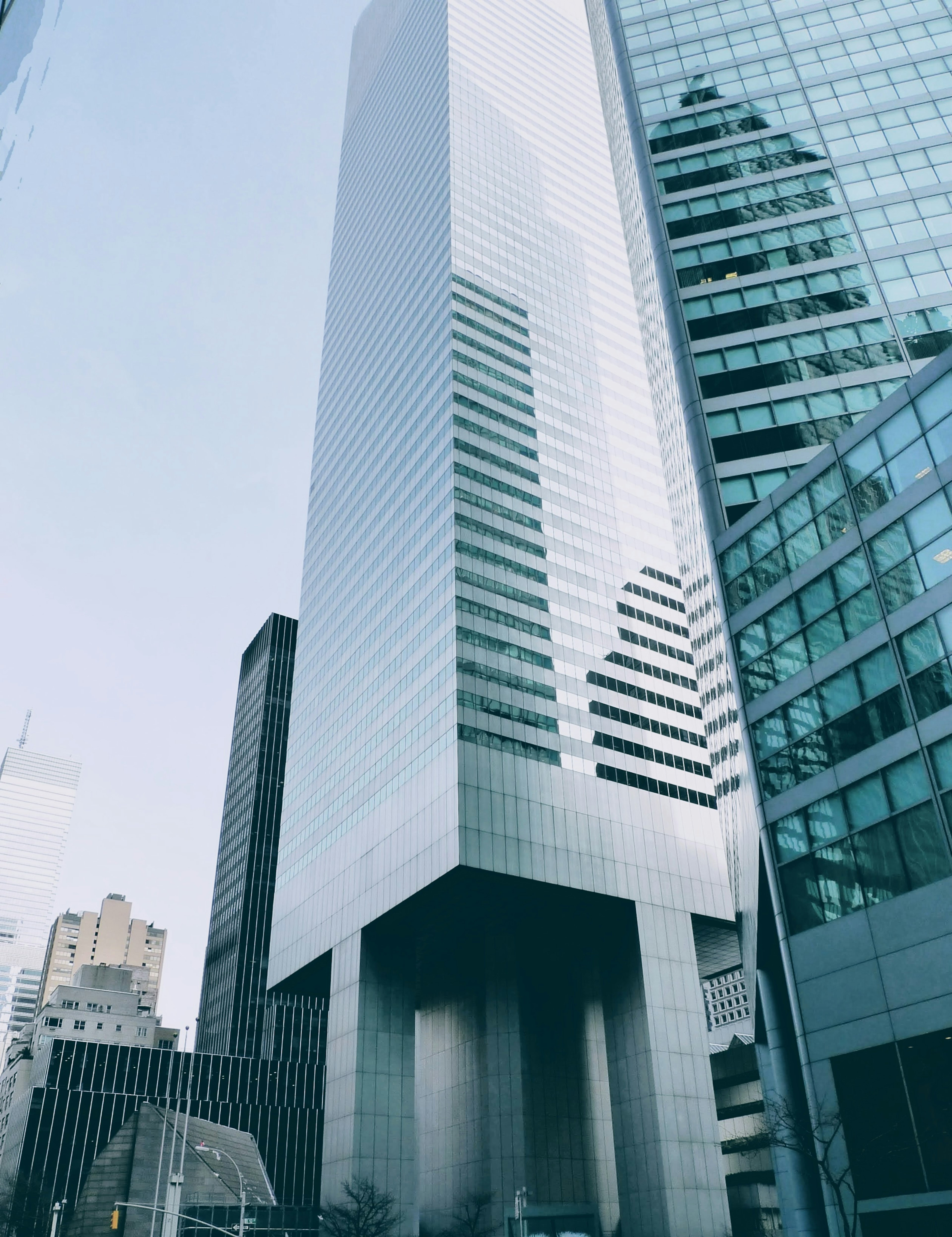 Urban landscape featuring a tall building with a glass facade