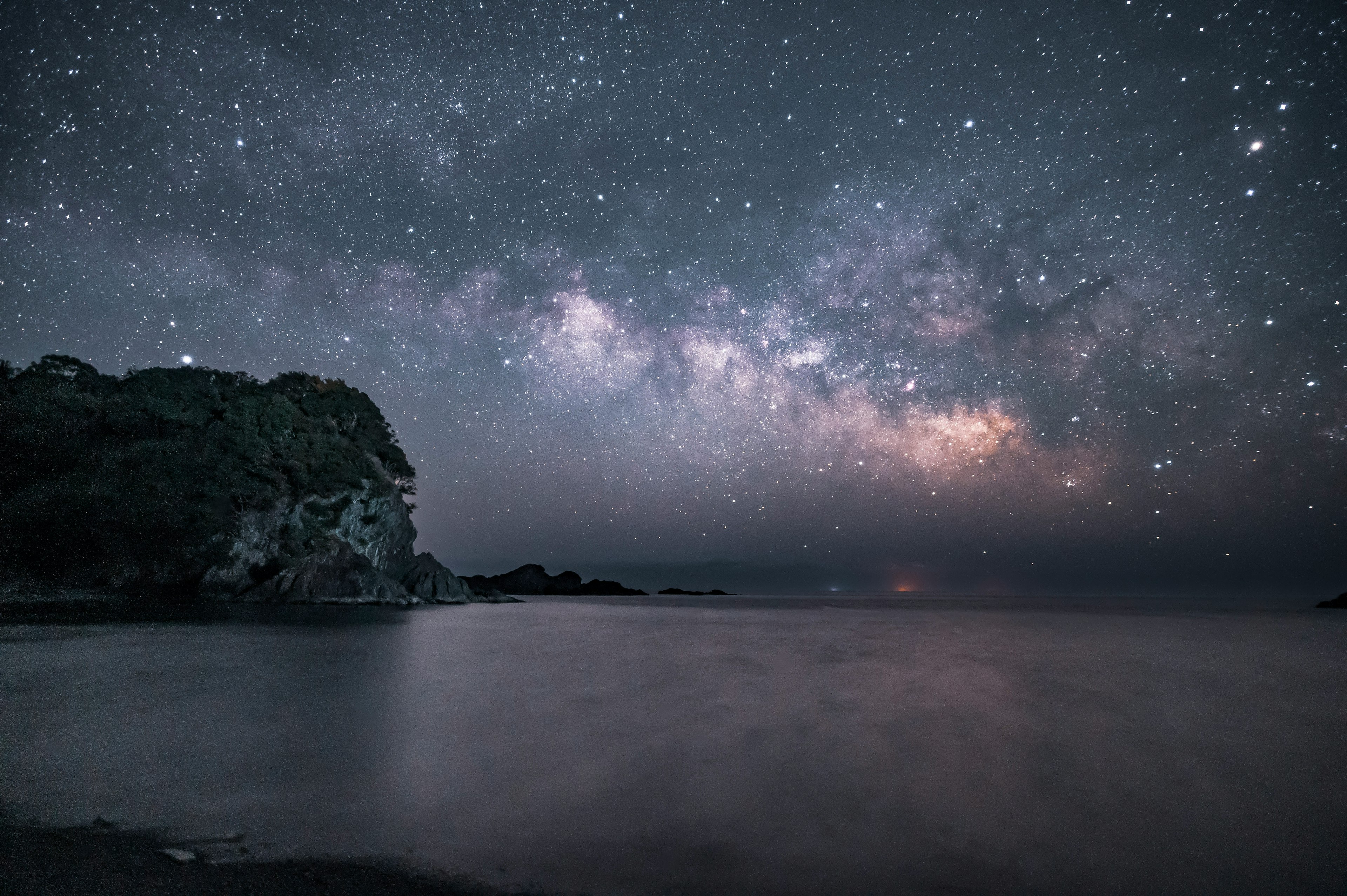 Starry night sky with the Milky Way and calm ocean