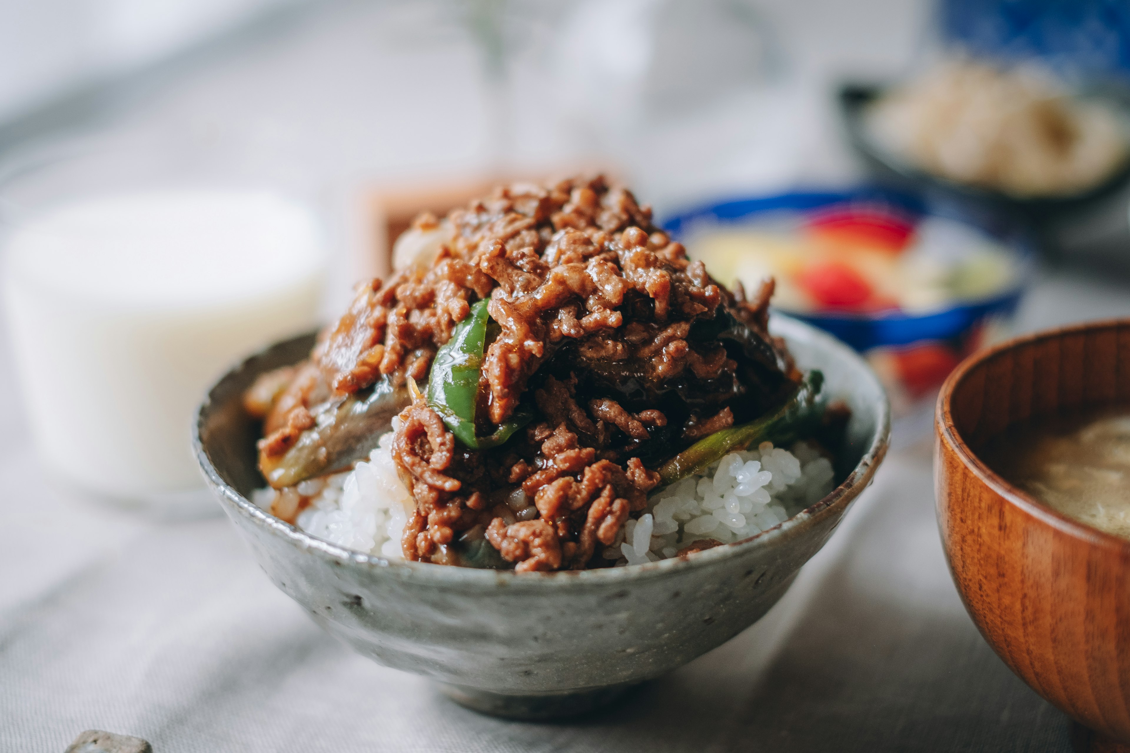 Bowl of rice topped with minced meat and vegetables