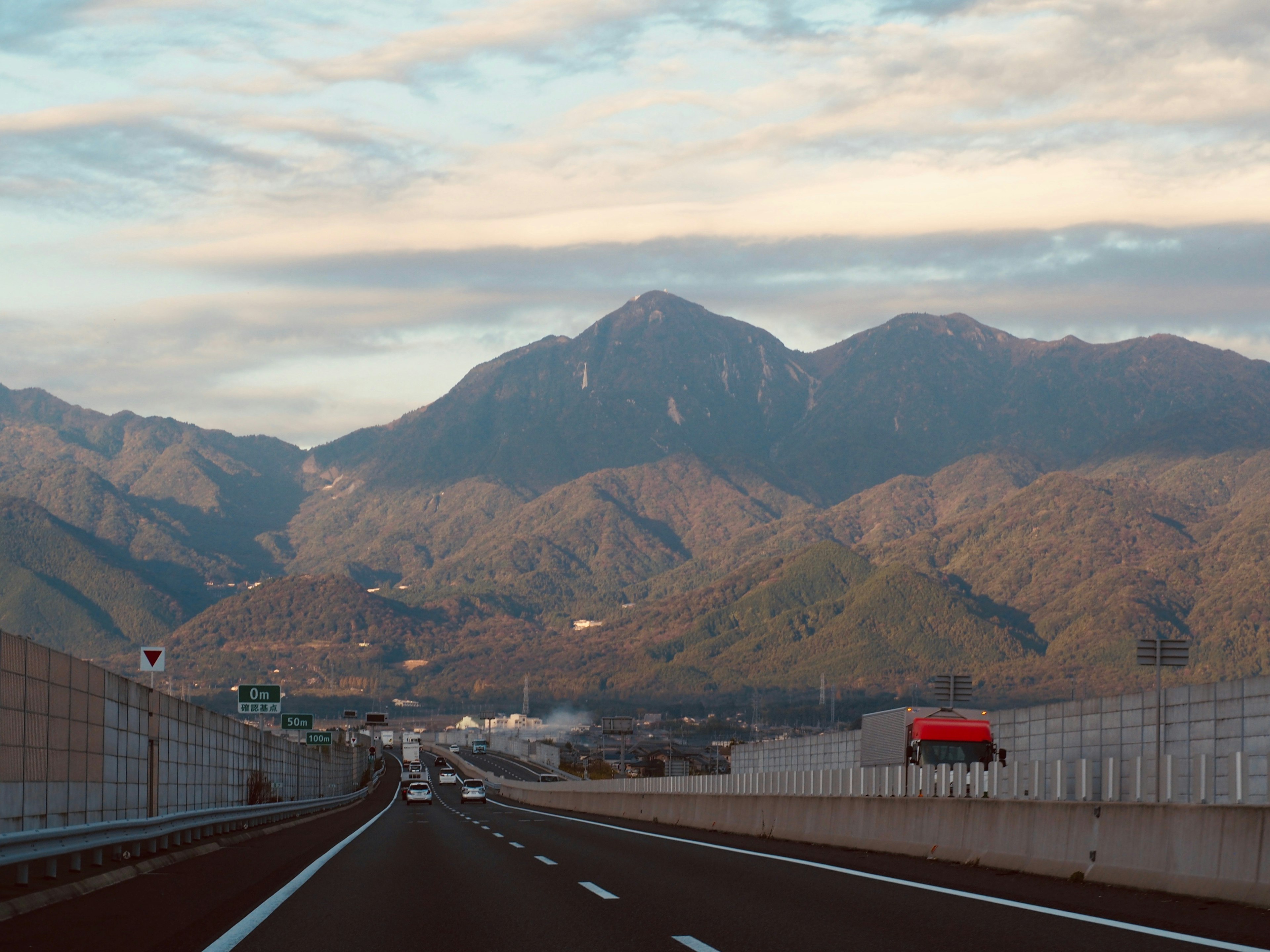 Scenic view of a highway with mountains in the background