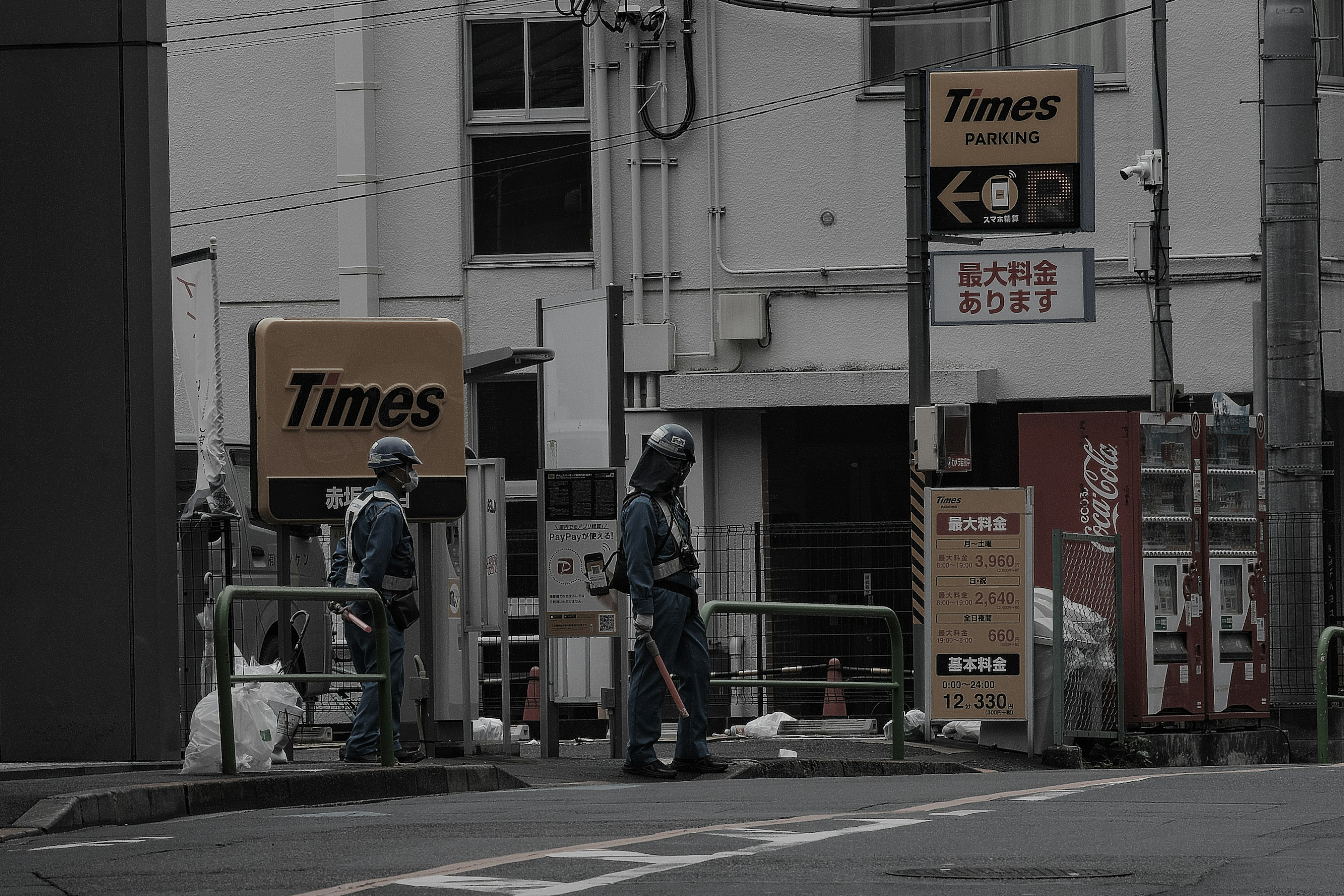 Workers at a street corner with Times signage