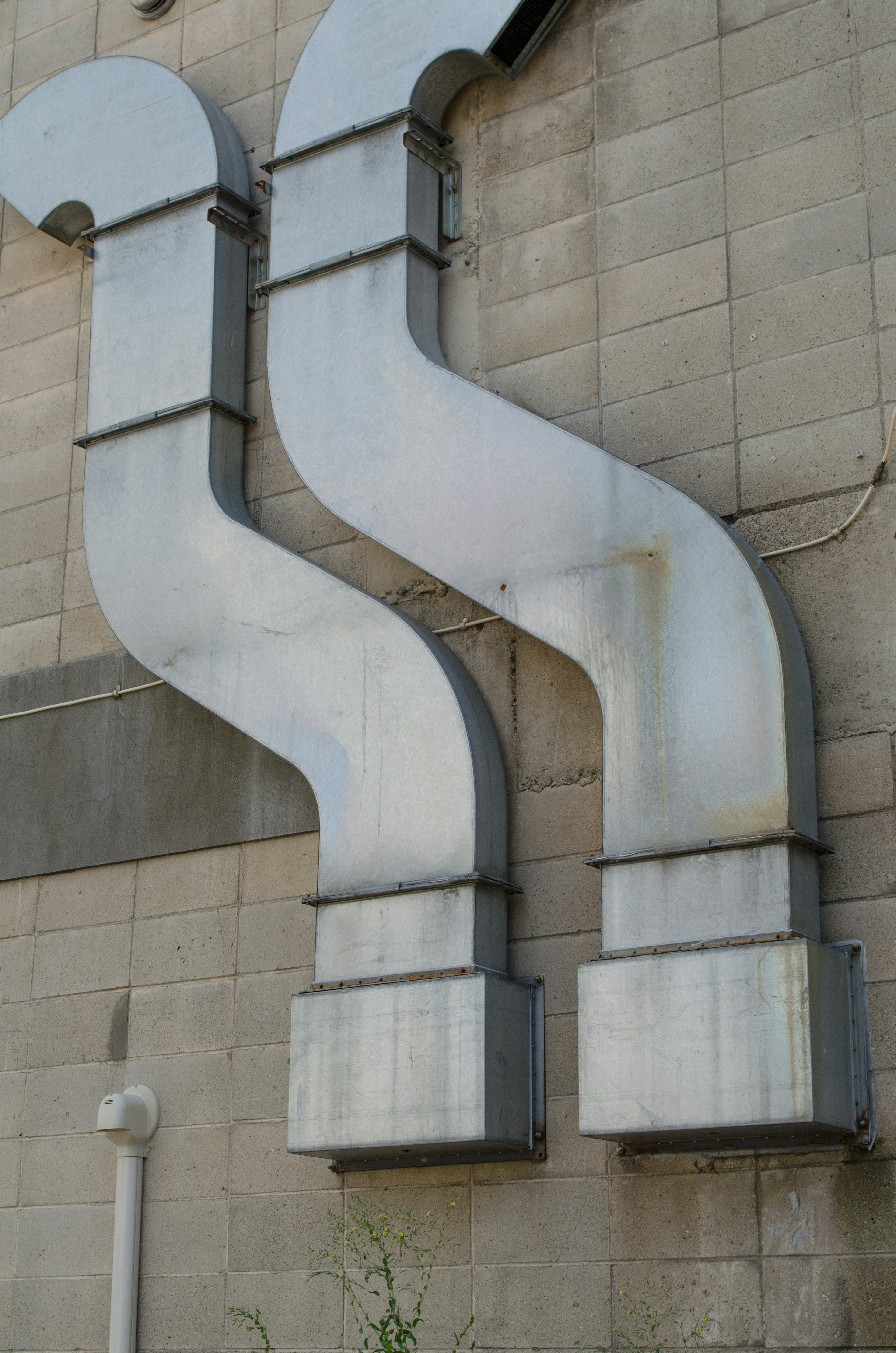 Metal pipes attached to a wall structure