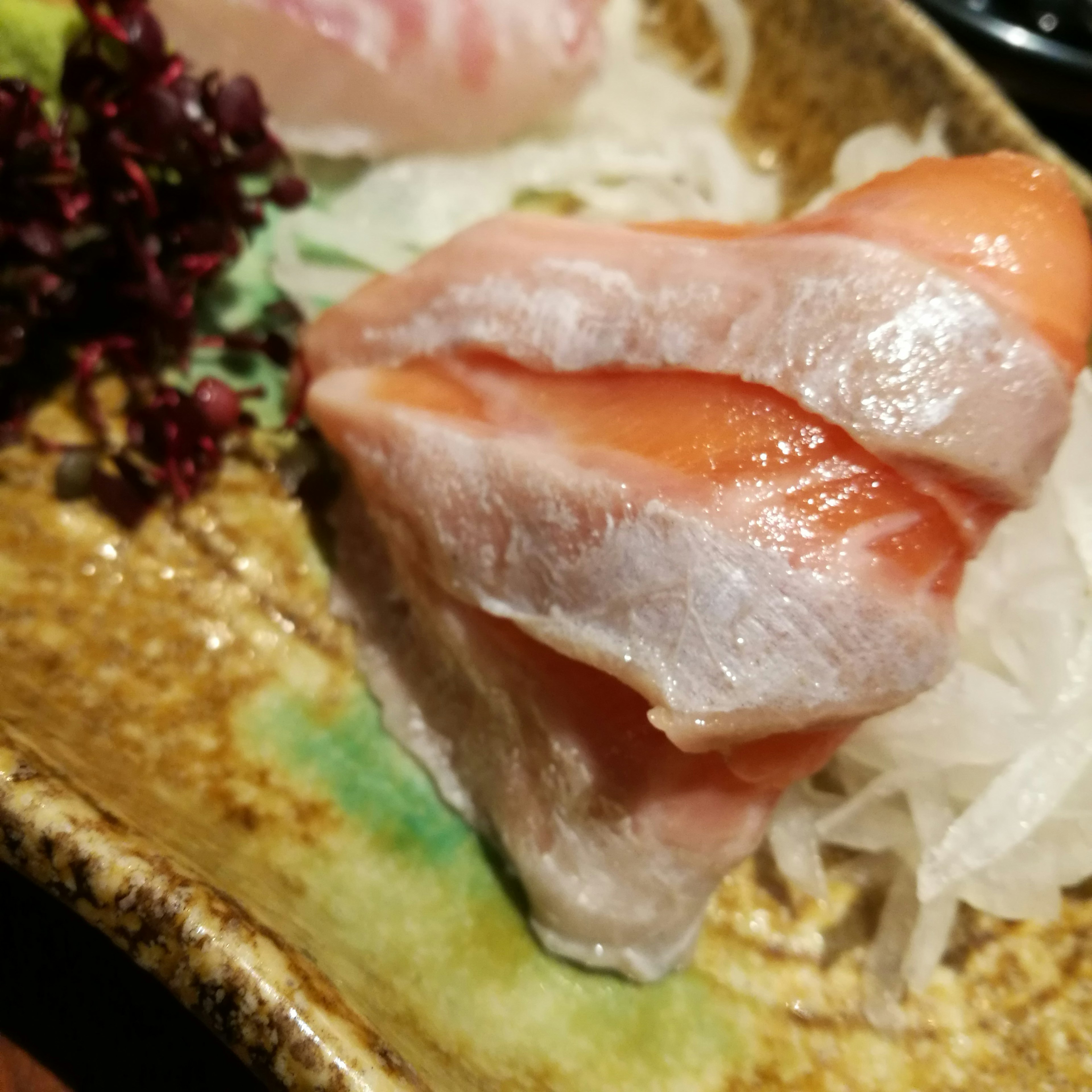 Fresh sashimi presentation with colorful garnishes