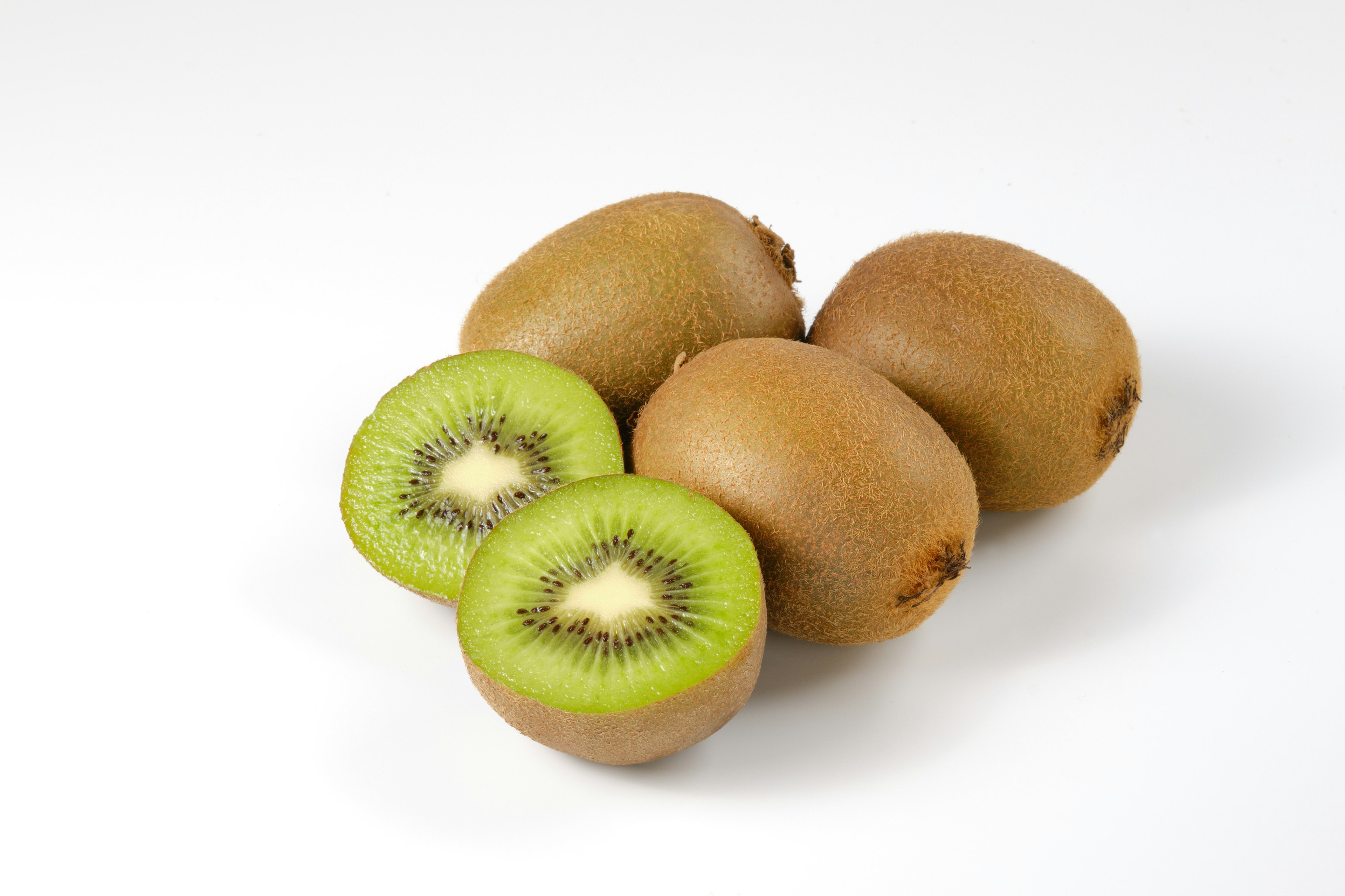 A simple image of kiwi fruits with one cut in half showing the green interior